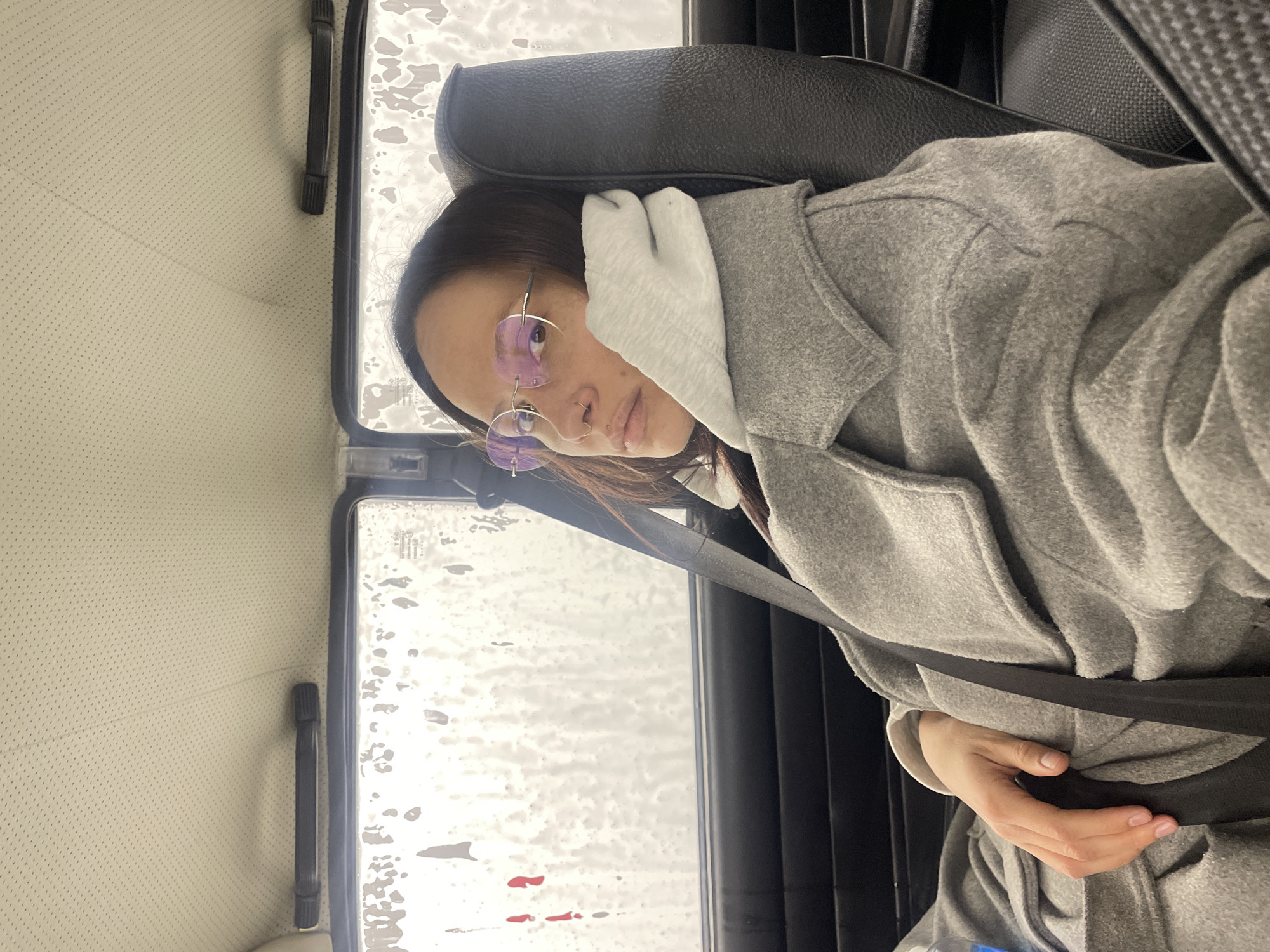 Person in gray coat observed seated in vehicle, Izhevsk