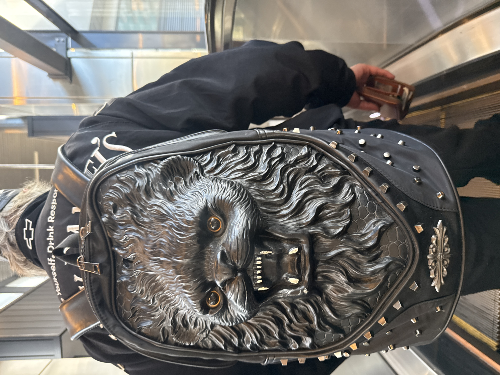 Escalator ride in Khimki featuring a bold 3D lion backpack