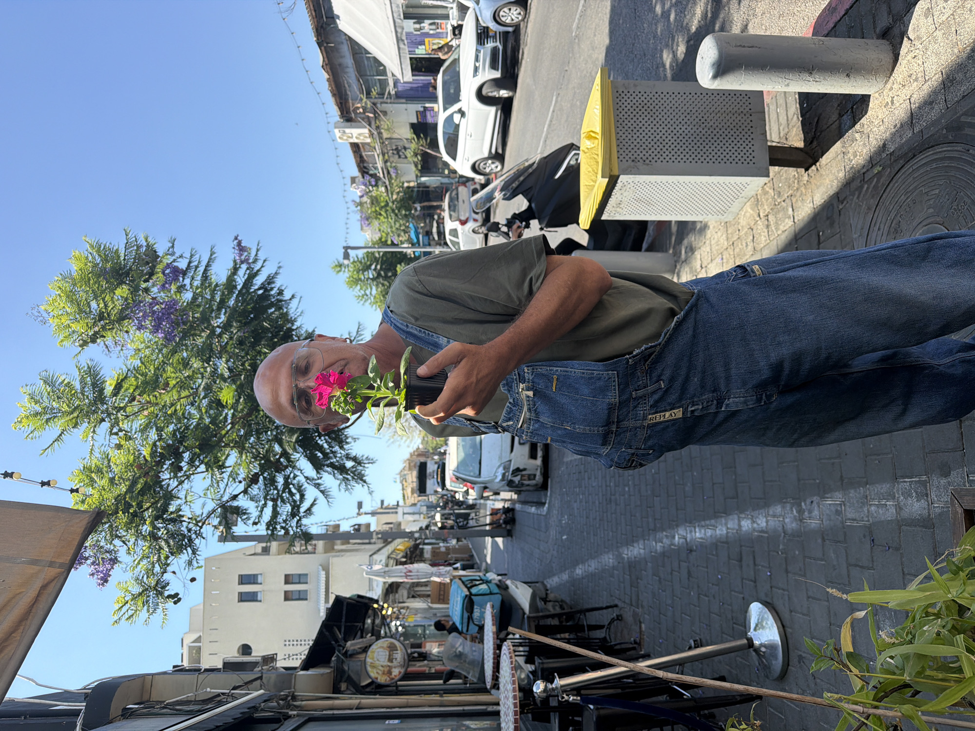 Street scenes captured in Tel Aviv featuring flower vendor