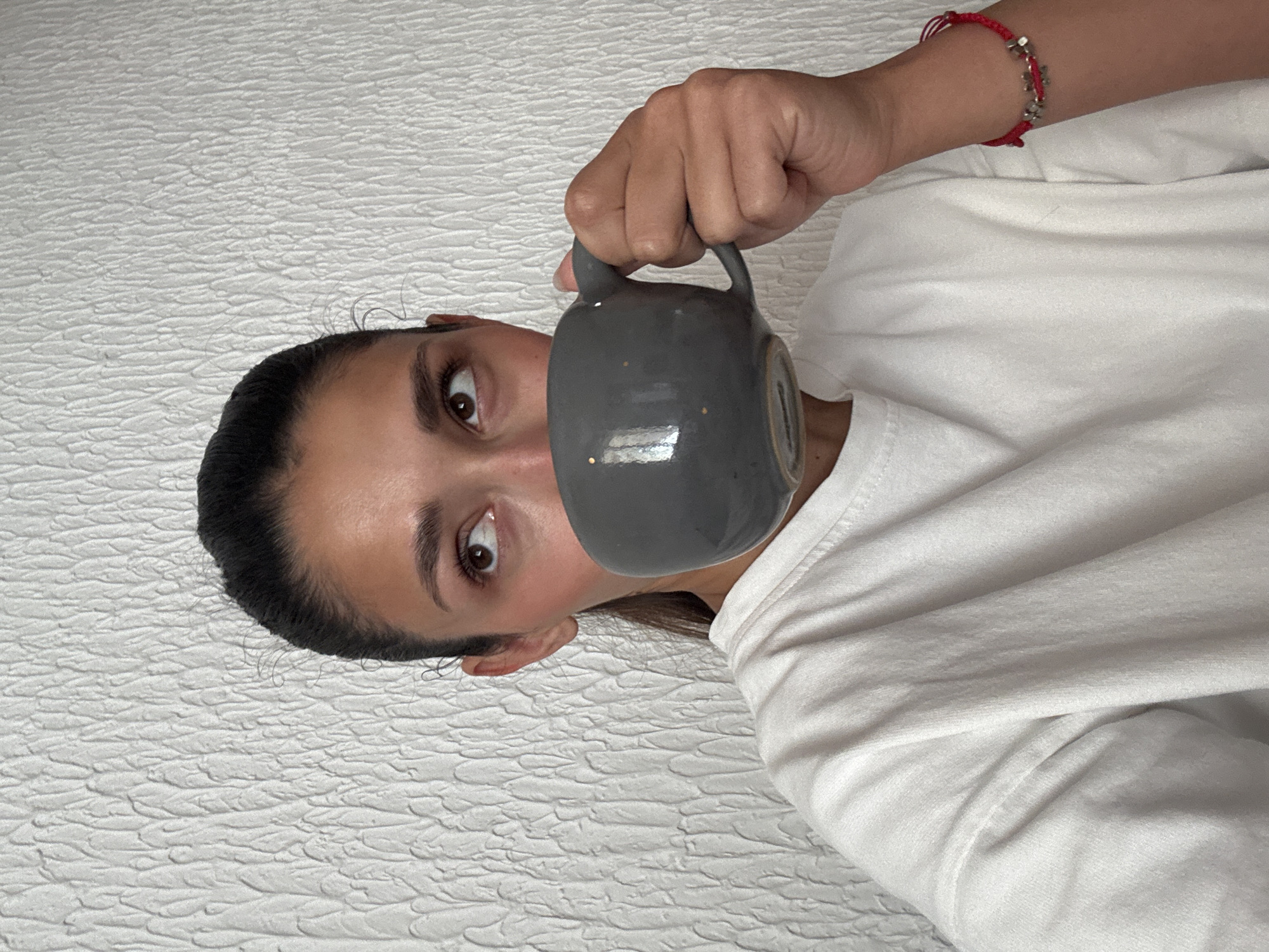 Woman drinks coffee at home in Sutomore, Montenegro