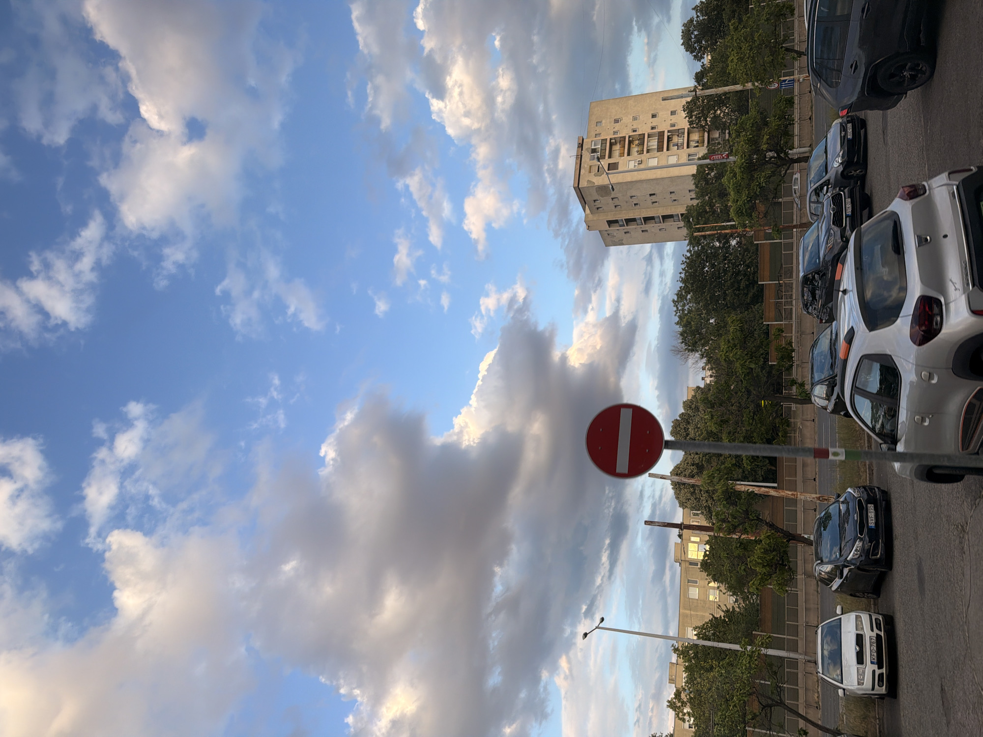 Budapest transit street with graffiti, buses, and shifting skies