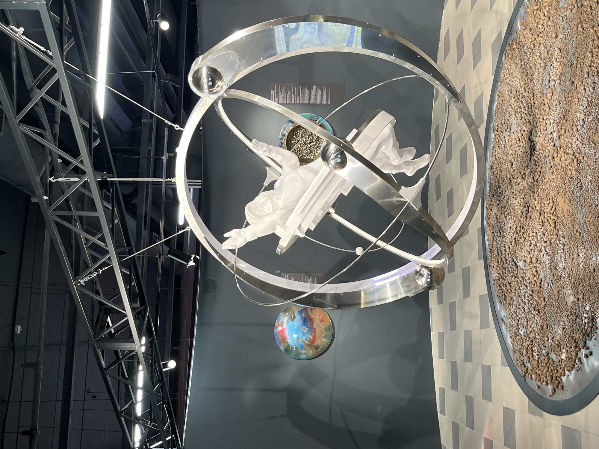 Museum exhibit features astronomical sculpture and dandelion-shaped light fixtures