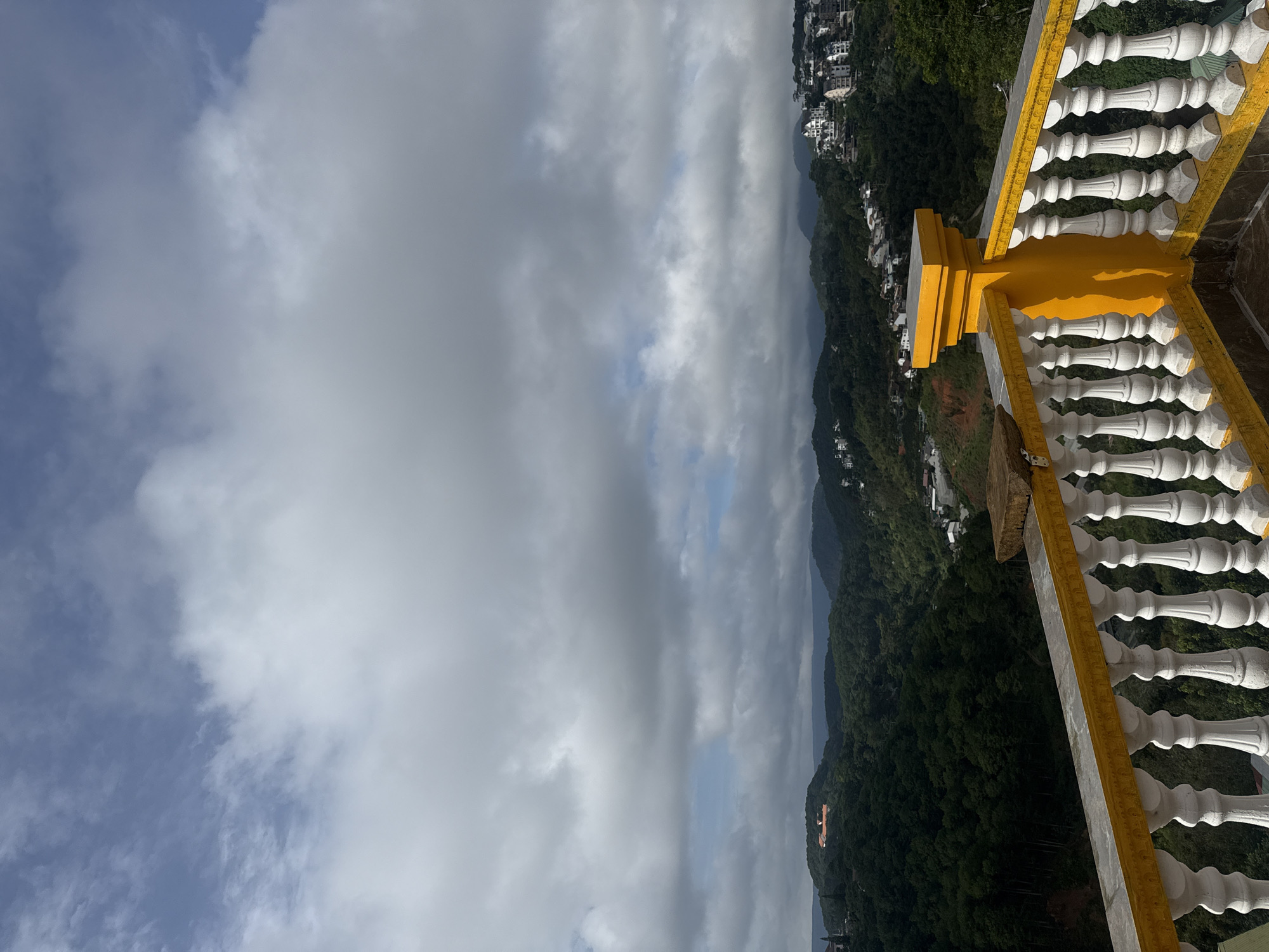Balcony yoga session overlooking Da Lat's hilly valley
