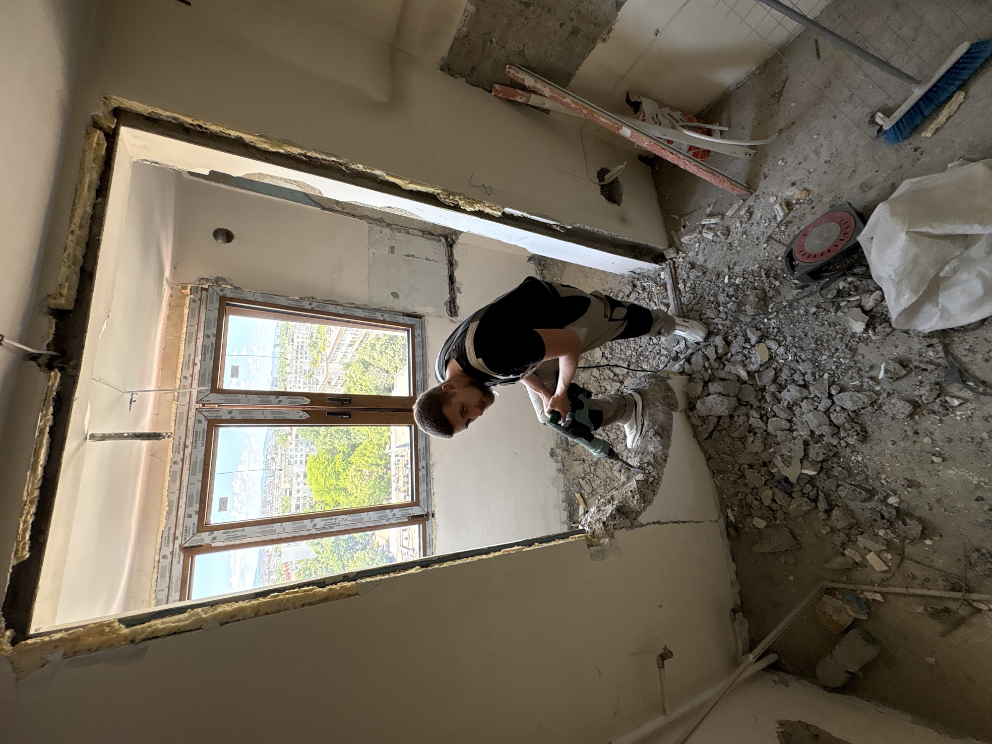 Man conducts demolition work with jackhammer in Sofia building