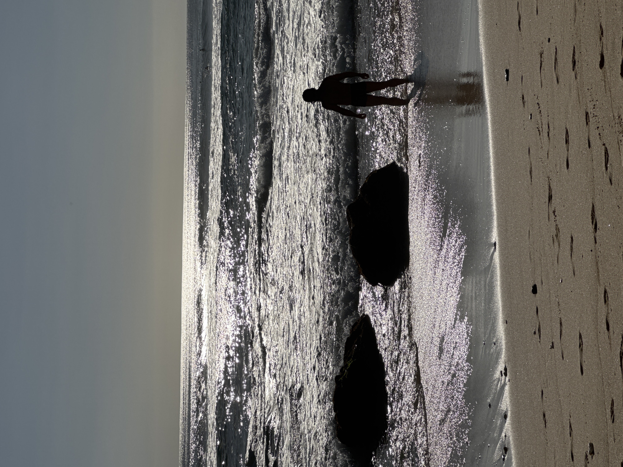 Morning beach life along Kuta Selatan's volcanic shoreline