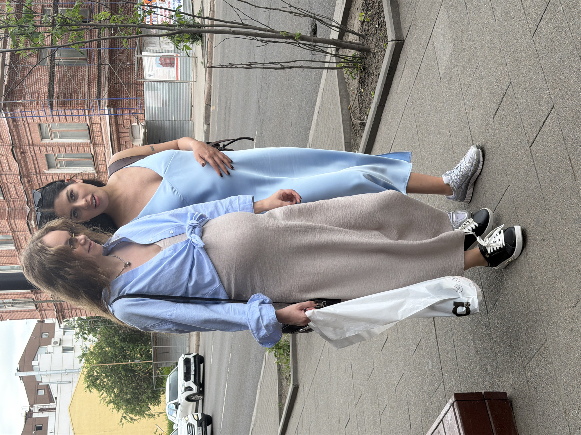 Summer foot traffic on a Krasnoyarsk sidewalk, June morning