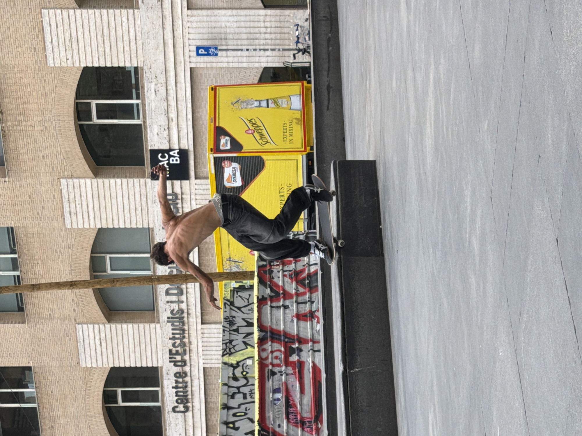 Skateboarders perform tricks at Barcelona plaza during midday session