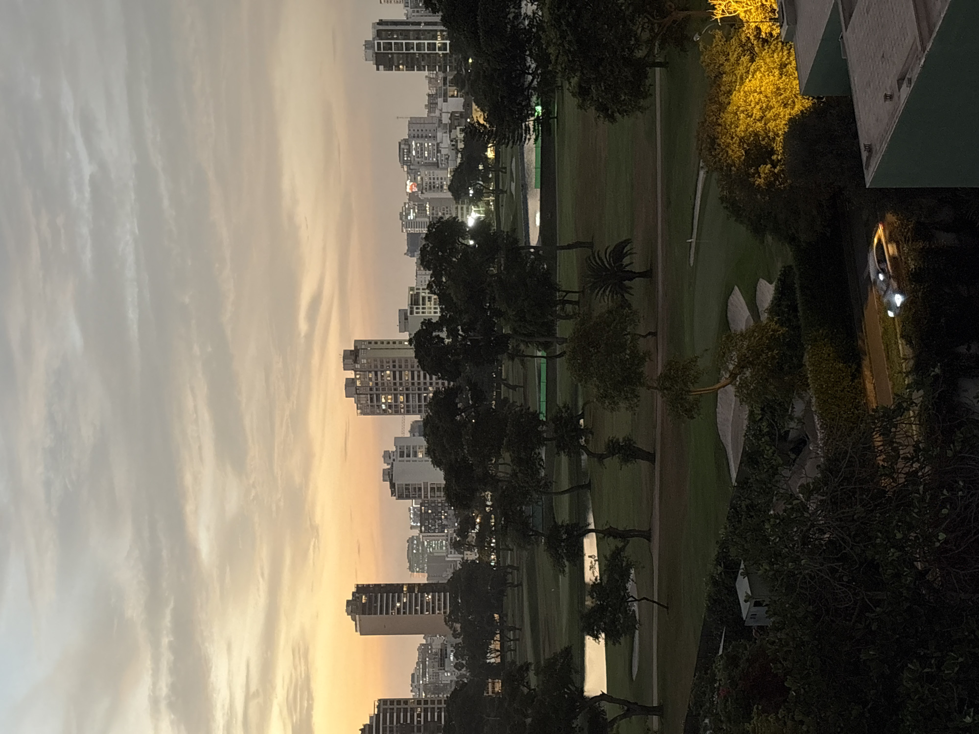 Woman takes elevator selfies amid San Isidro sunset cityscape