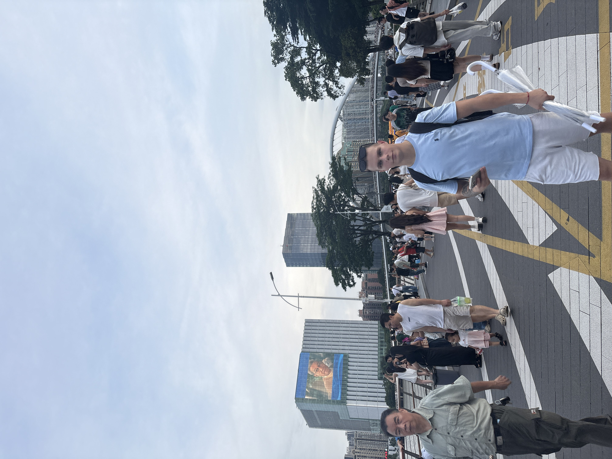 Pearl River promenade buzzing near Canton Tower on a cloudy morning