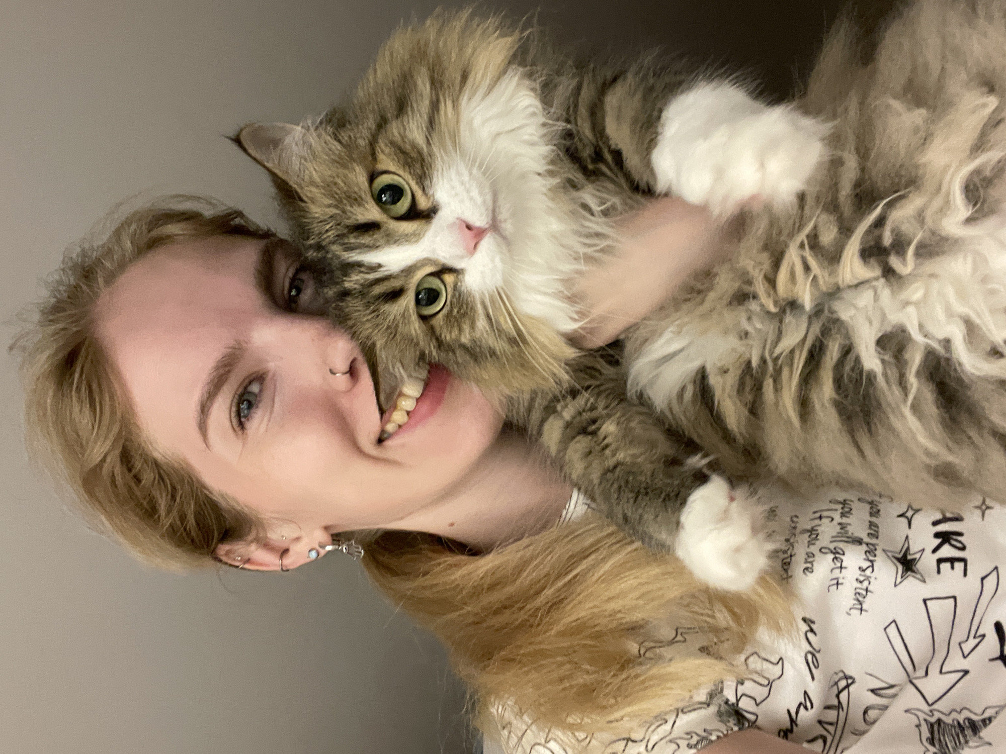 Woman and fluffy cat photographed together in Izhevsk home