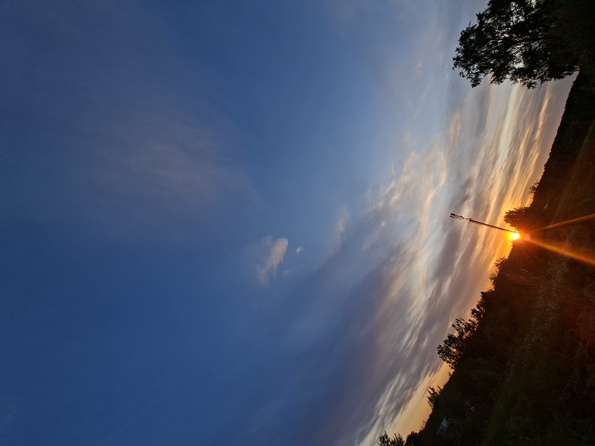 Sunset observed with communication tower silhouette captured by witness