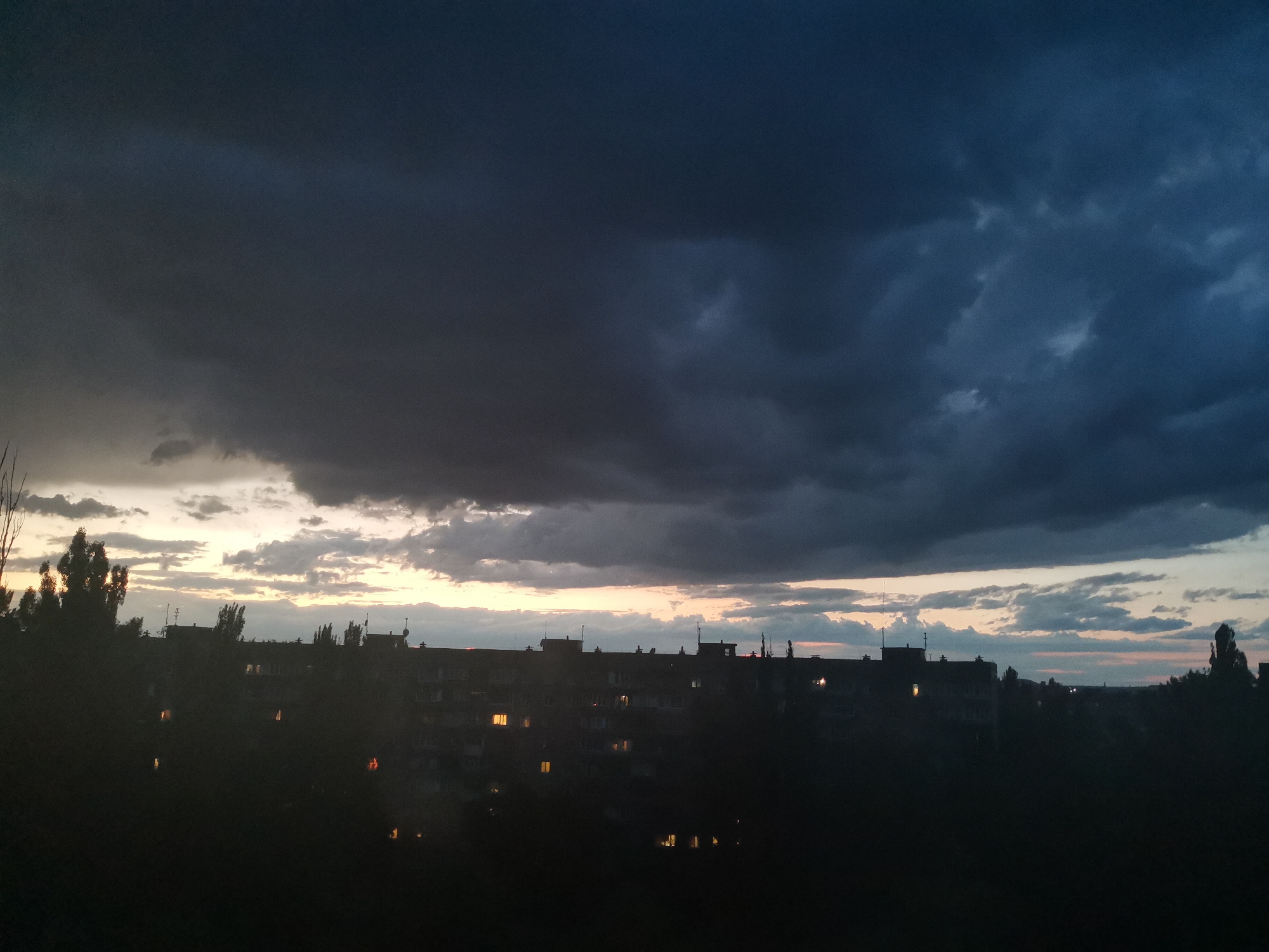 Kryvyi Rih residential block under brooding dusk skies