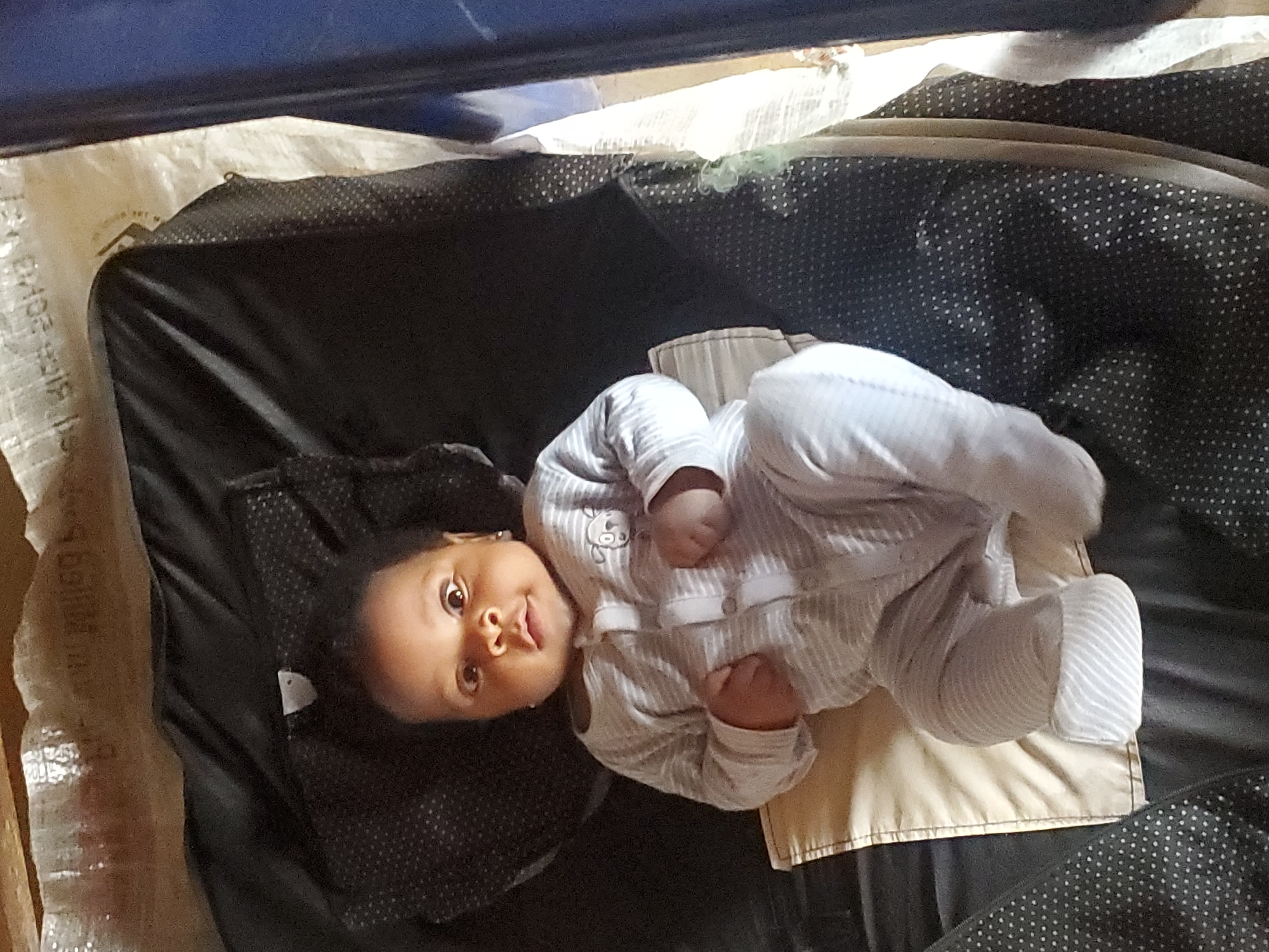 Baby in striped onesie observed in Ukwu-Abwa, Nigeria