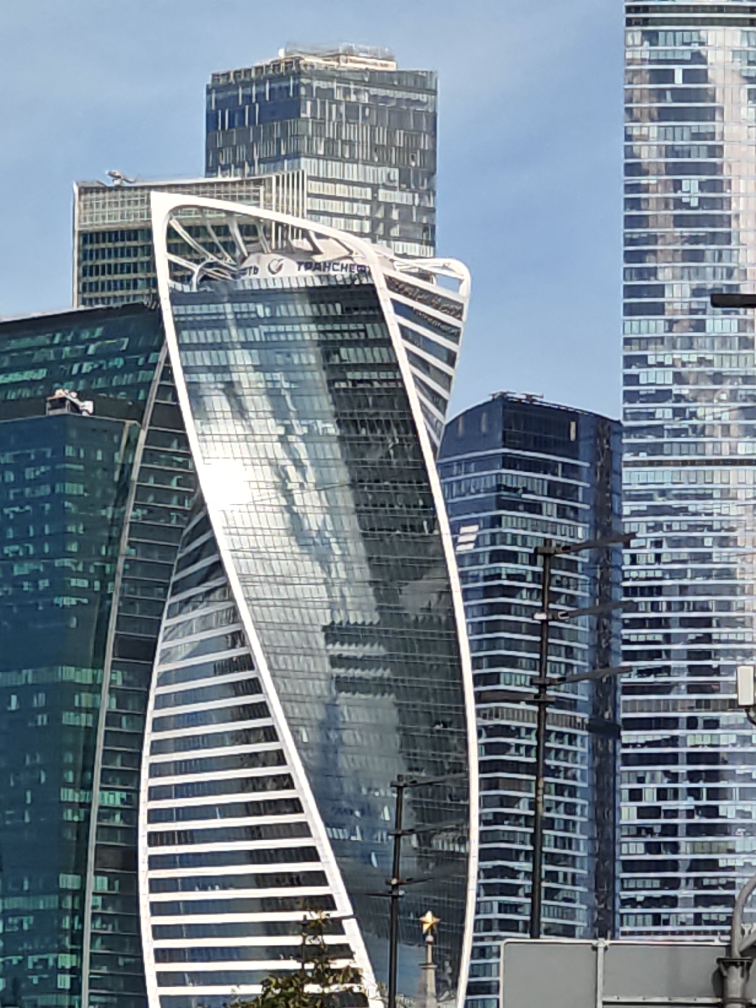 Moscow City towers and flower-lined walkways on a June morning