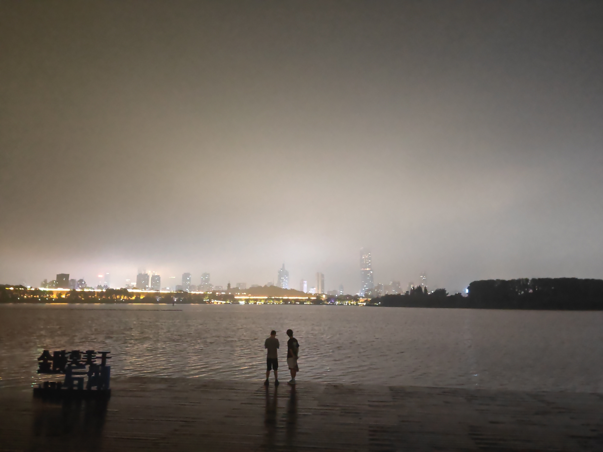 Night at Xuanwu Lake: waterfront calm and a winged statue