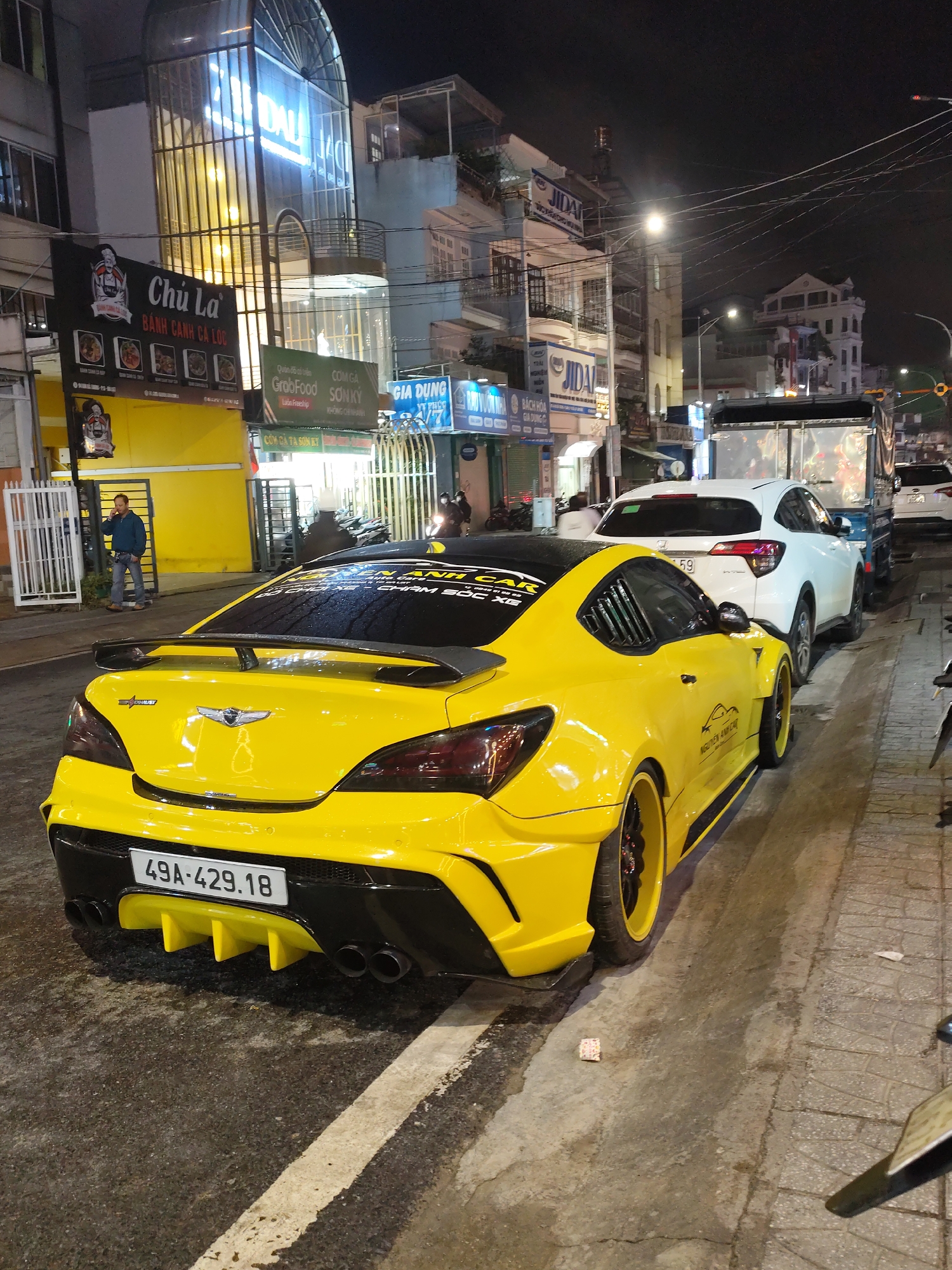 Da Lat's neon-lit streets on a busy wet night