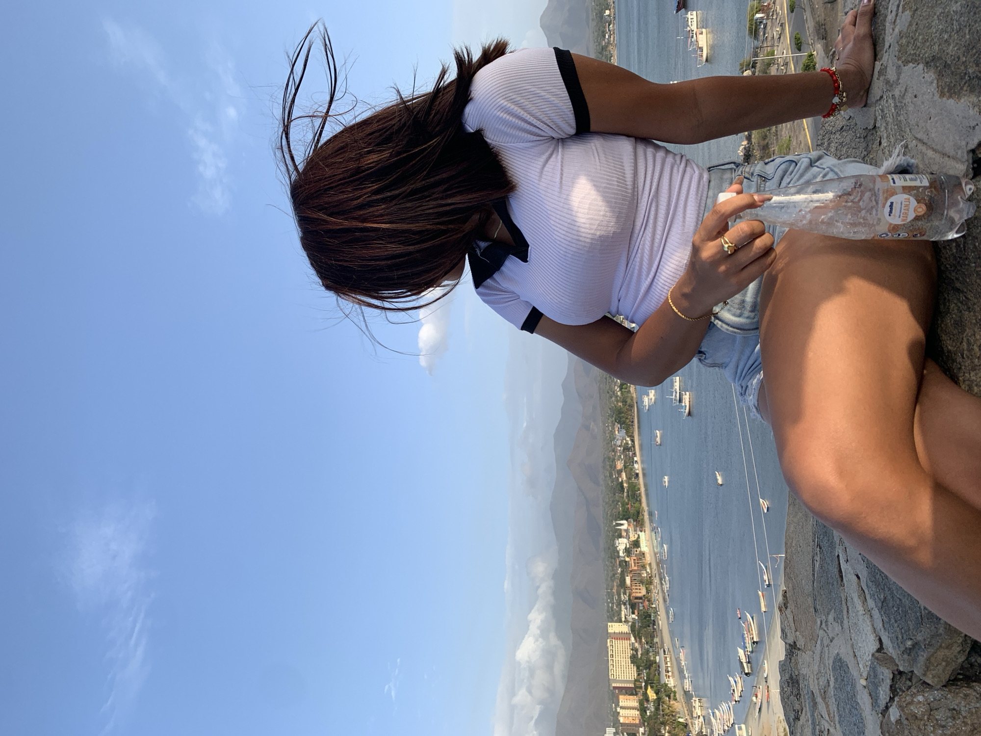Tourist documents Juan Griego sights during intense sunlight evening