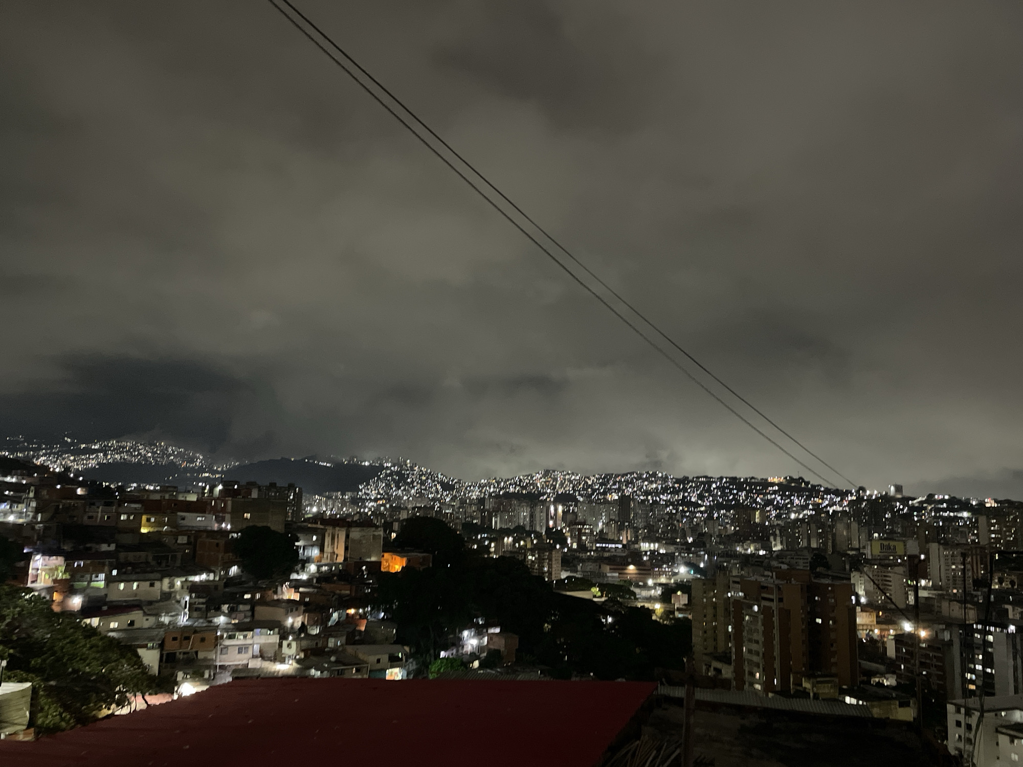 Nighttime religious procession with illuminated Jesus statue in Caracas