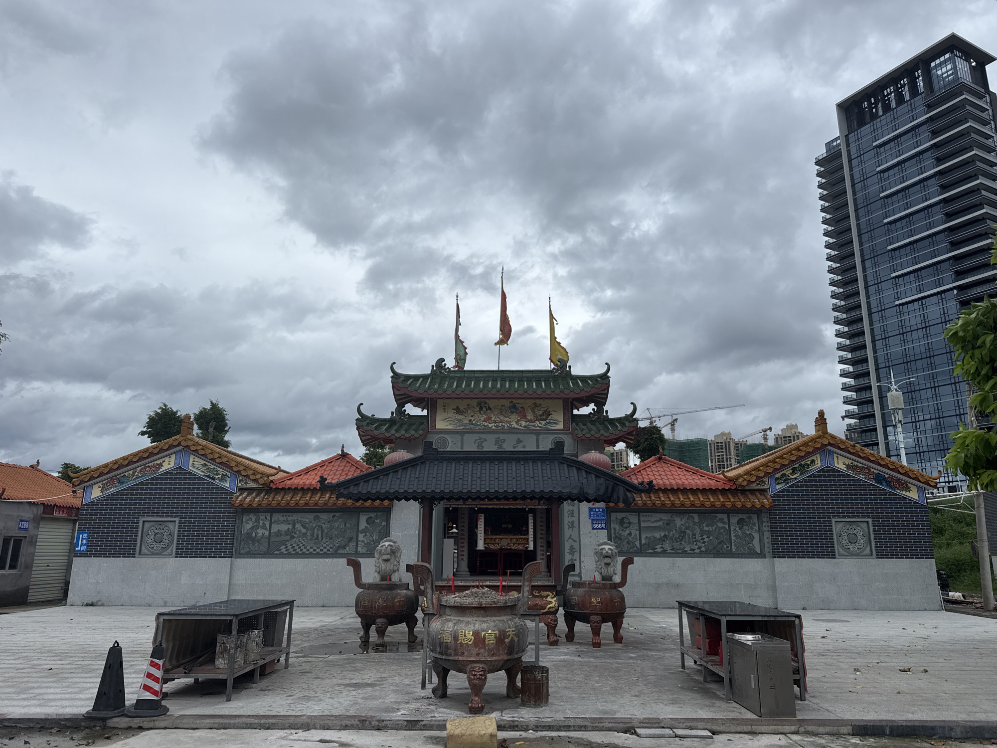 Traditional temple complex in Huizhou, framed by modern city