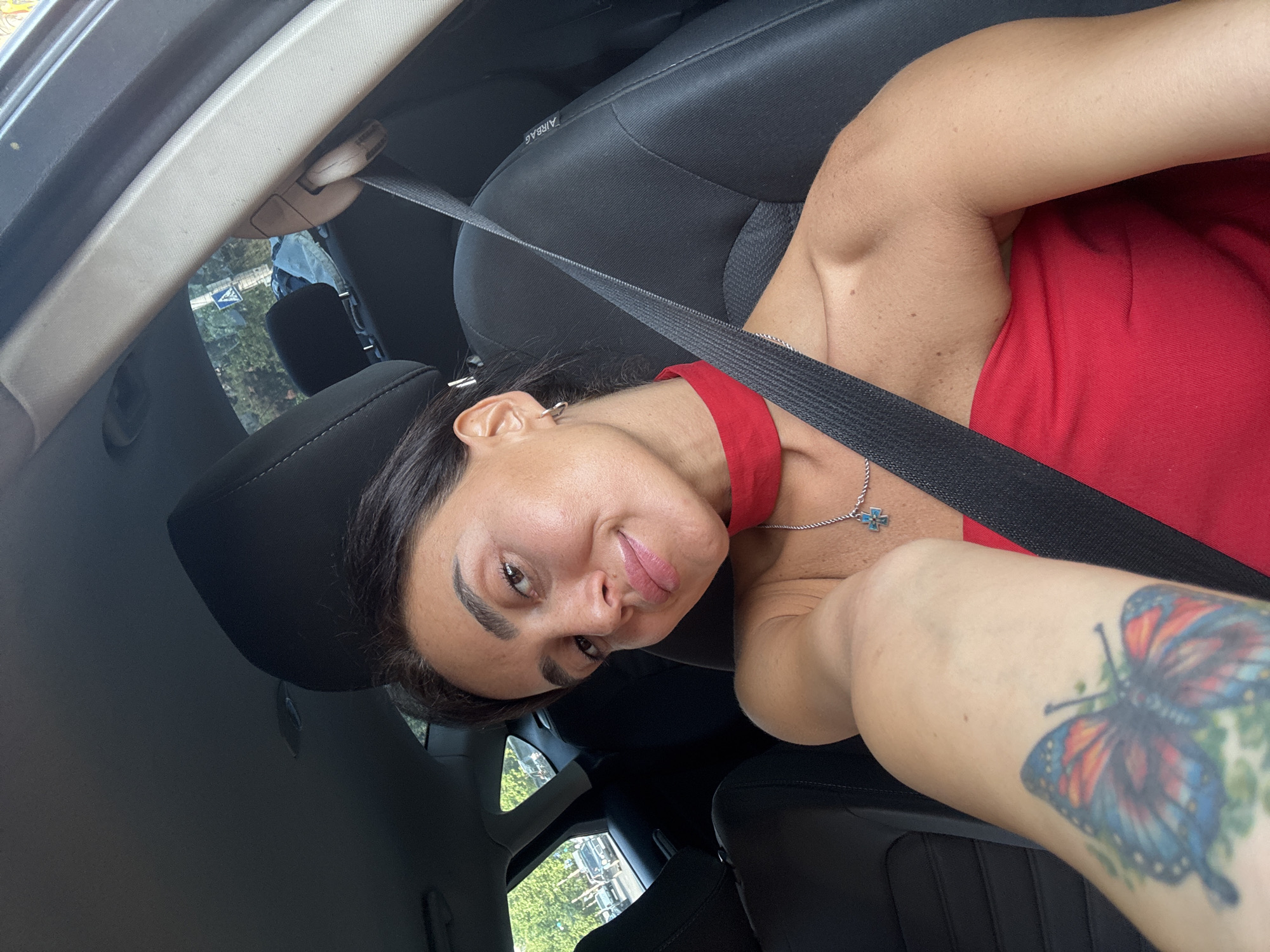 Self-portraits in a Tbilisi car, red top and layered necklaces