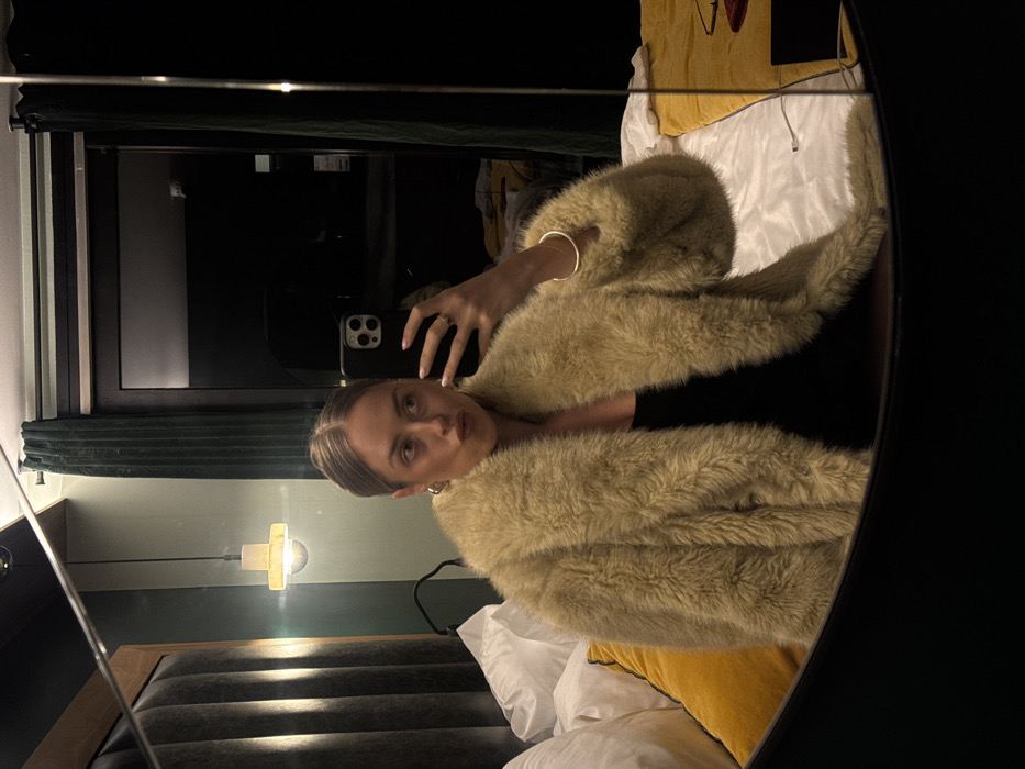 Woman takes fashion selfies in Courchevel hotel room