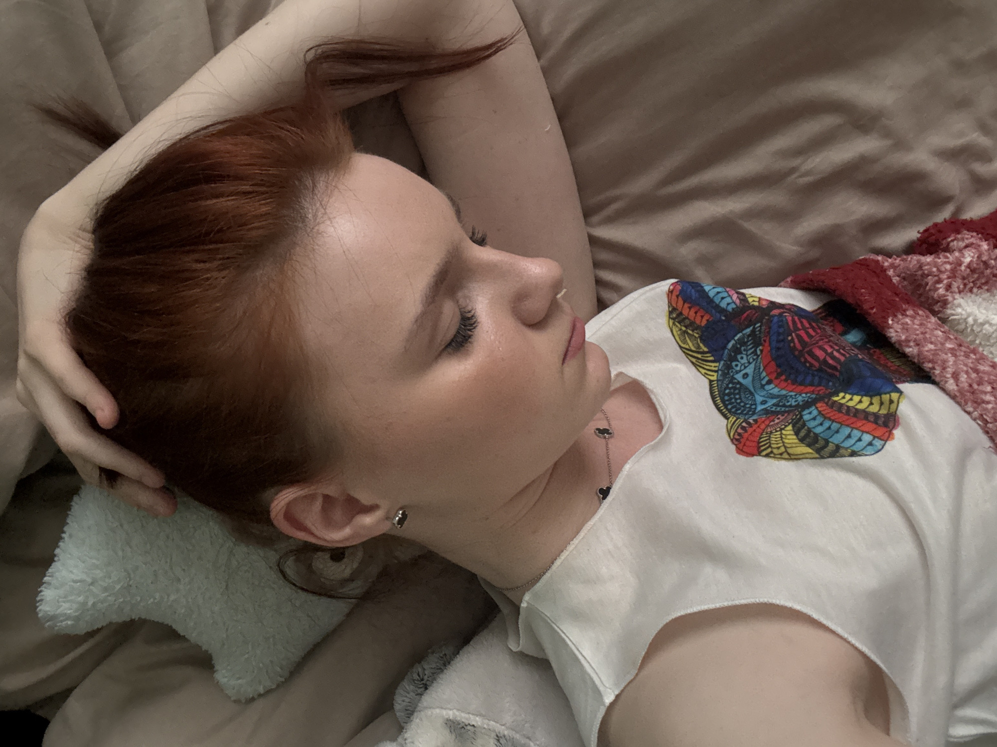 Woman rests on bed with light blue pillow