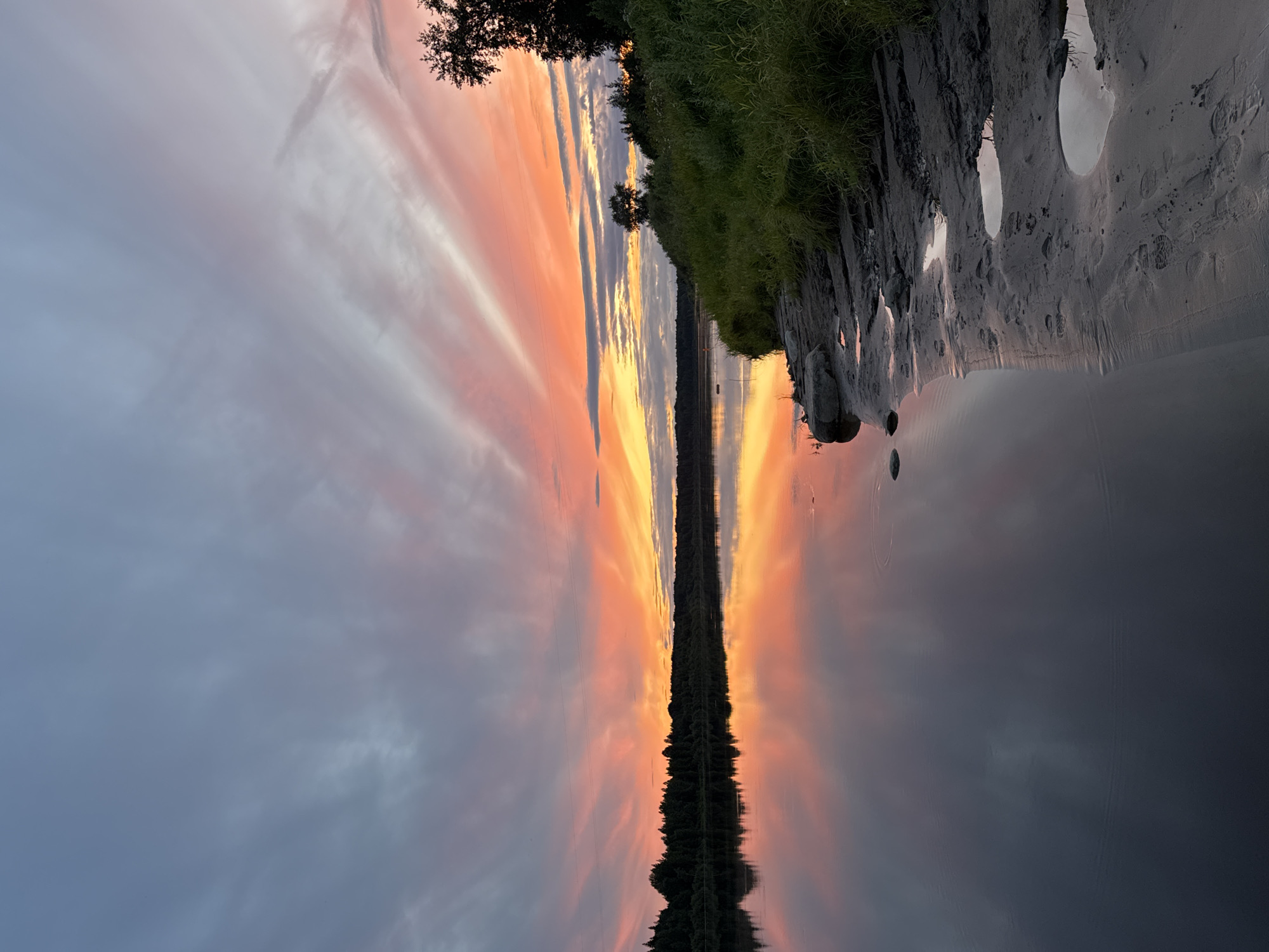 Sunset colors spread across a calm Russian river