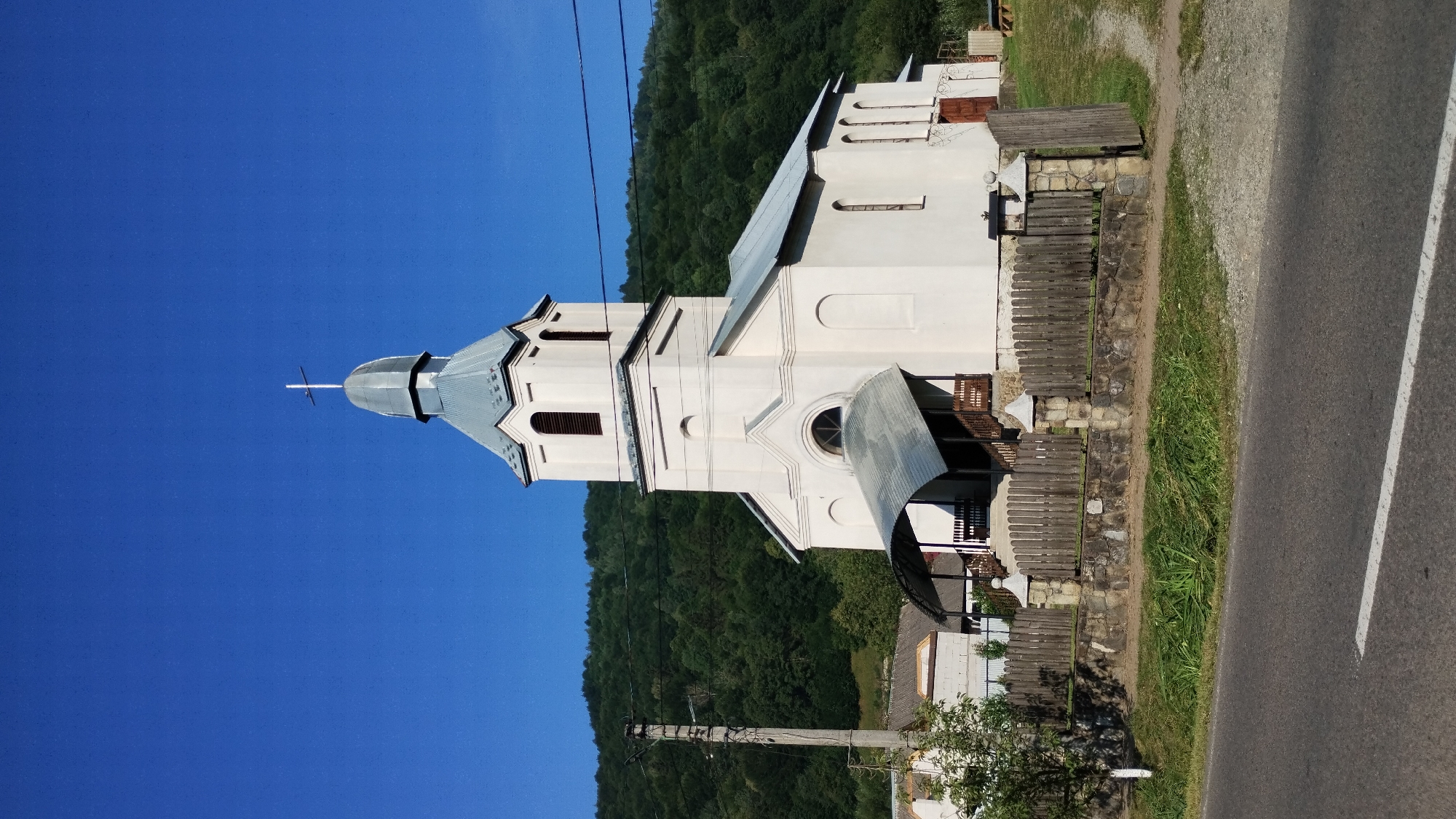 Rural village morning: church, river valley, and forest trails