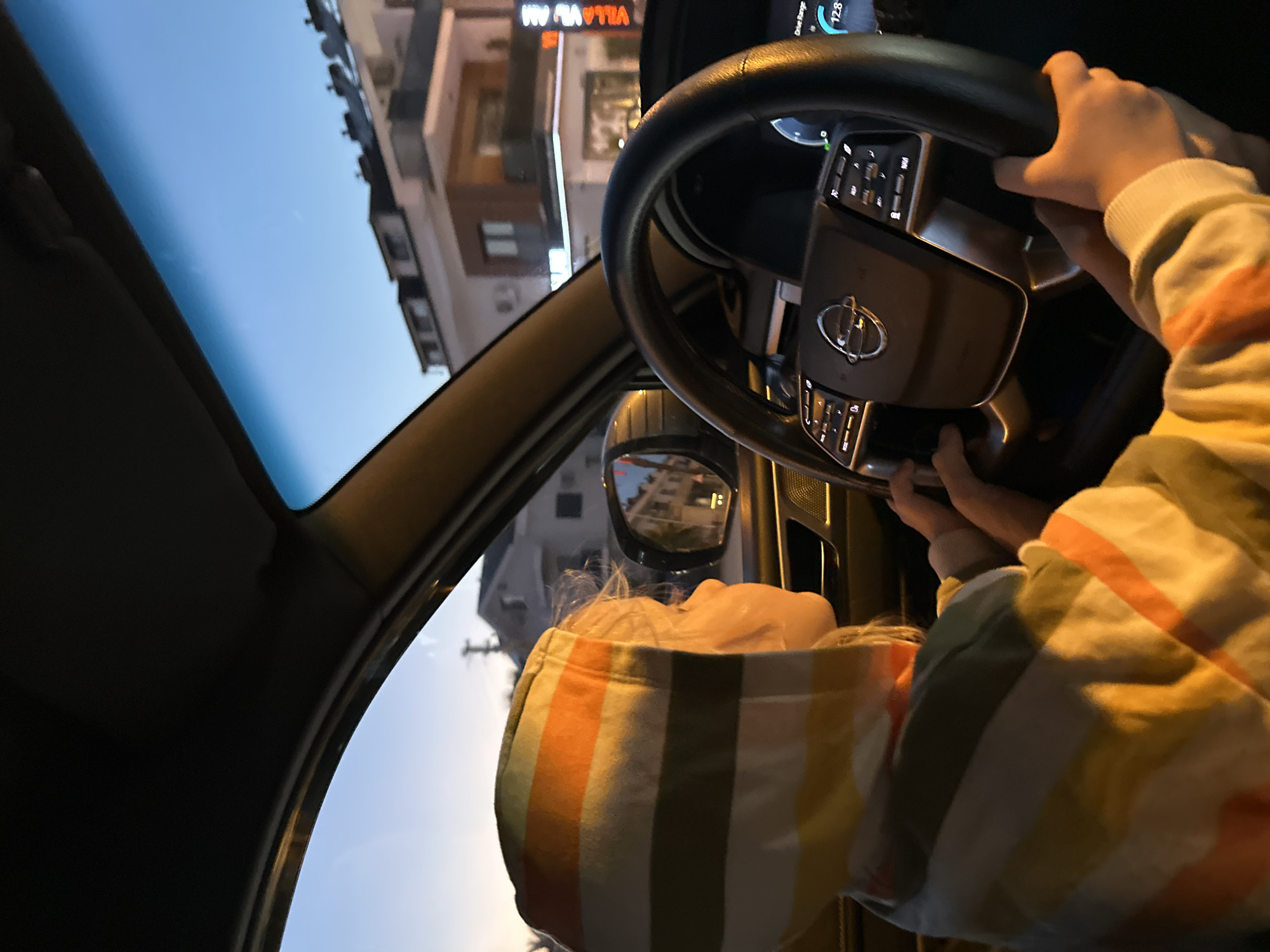 Child in striped sweater photographed inside car in Fethiye