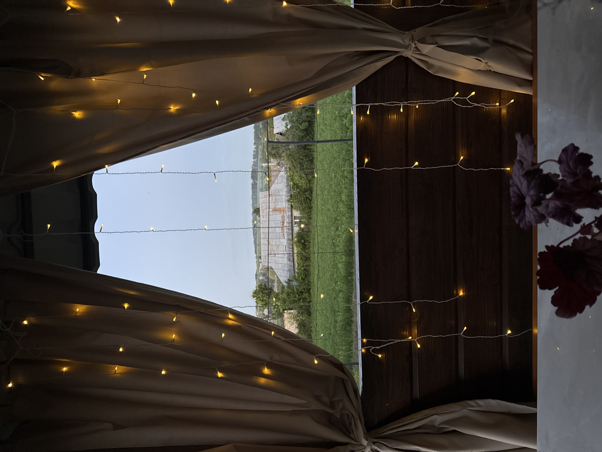 Gazebo, grain fields, and wildflowers at rural dusk