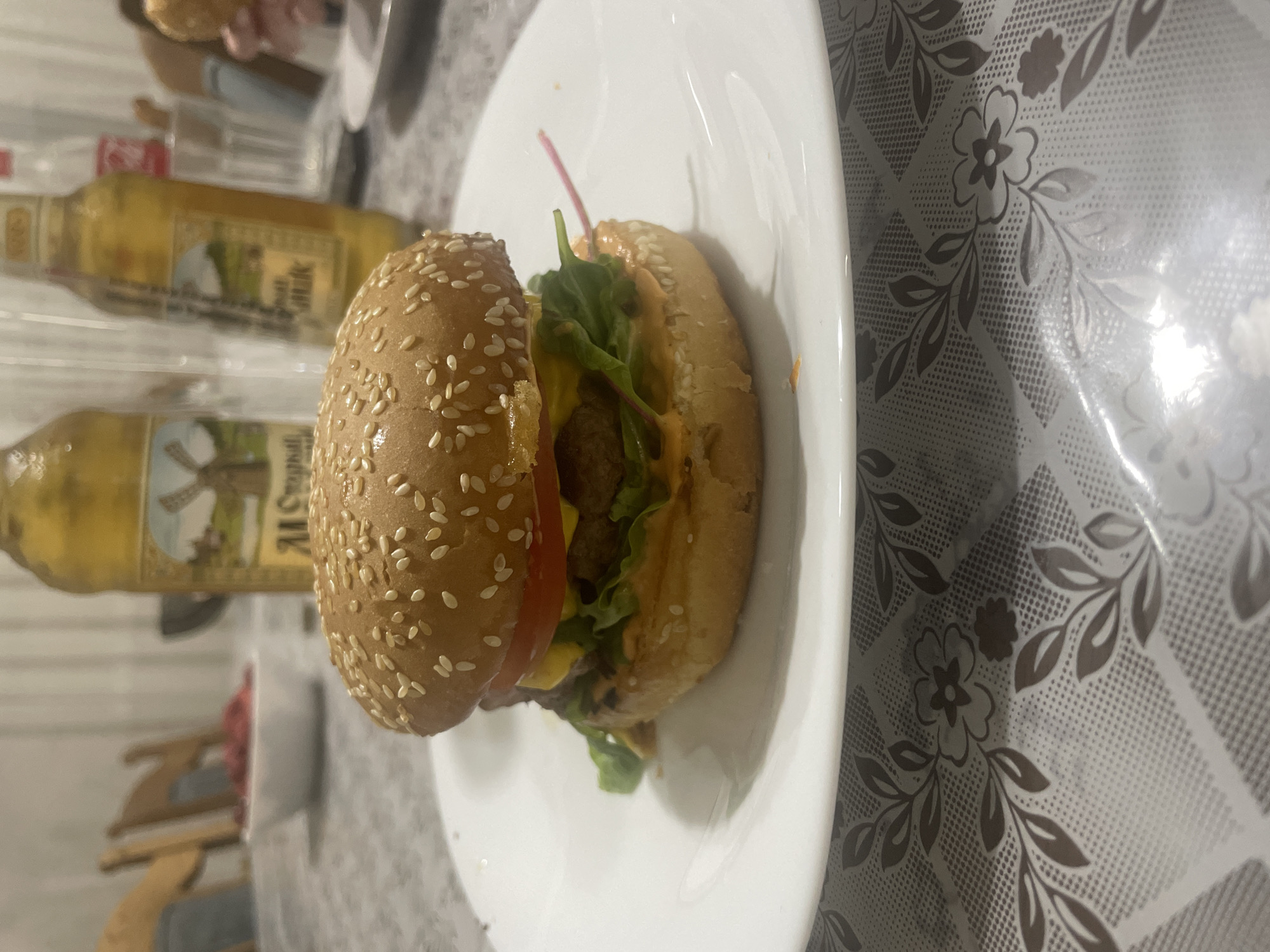 Homemade burgers and beers on a floral tablecloth
