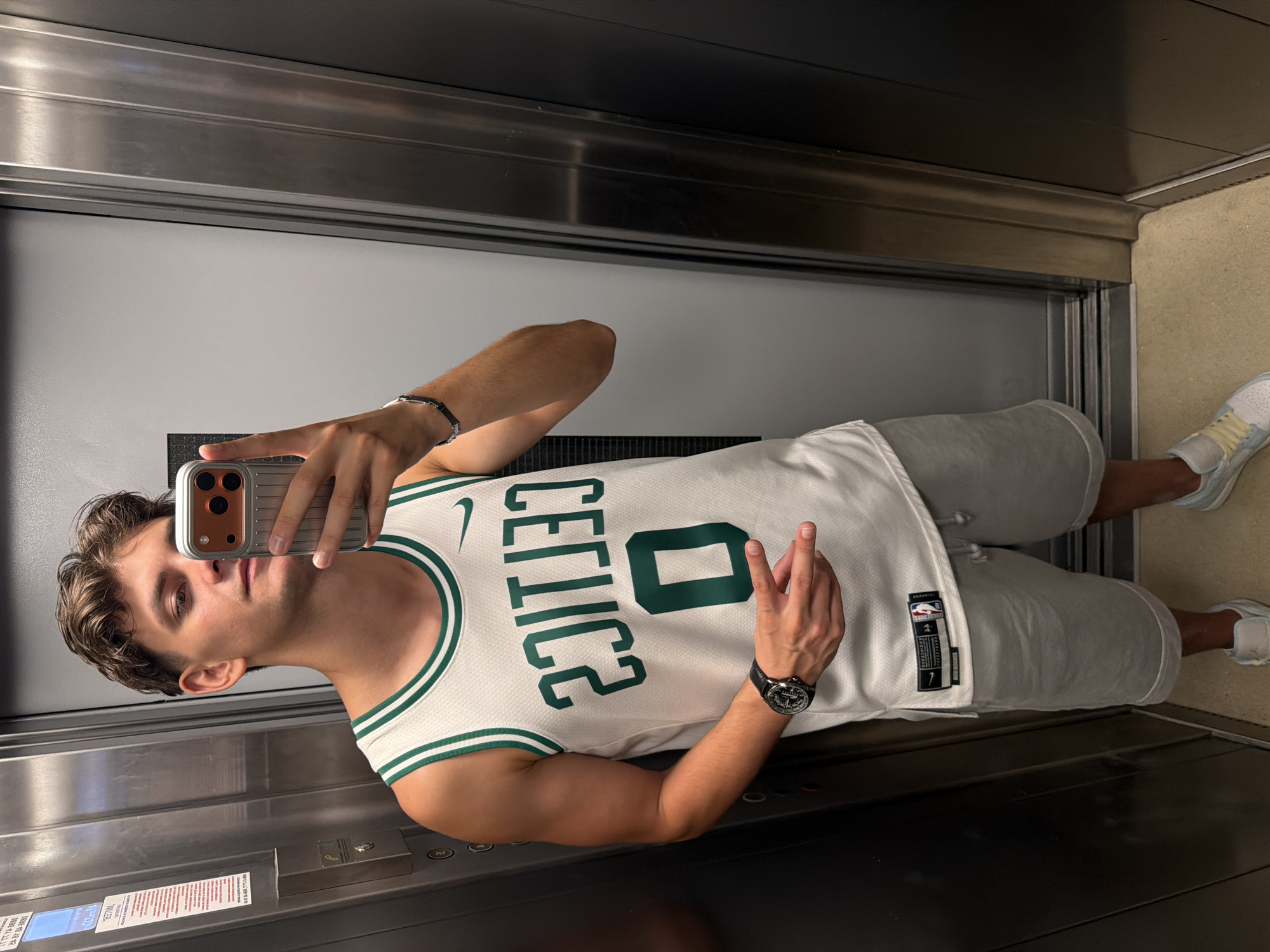 Elevator mirror selfie in Blagoevgrad, Celtics jersey on.