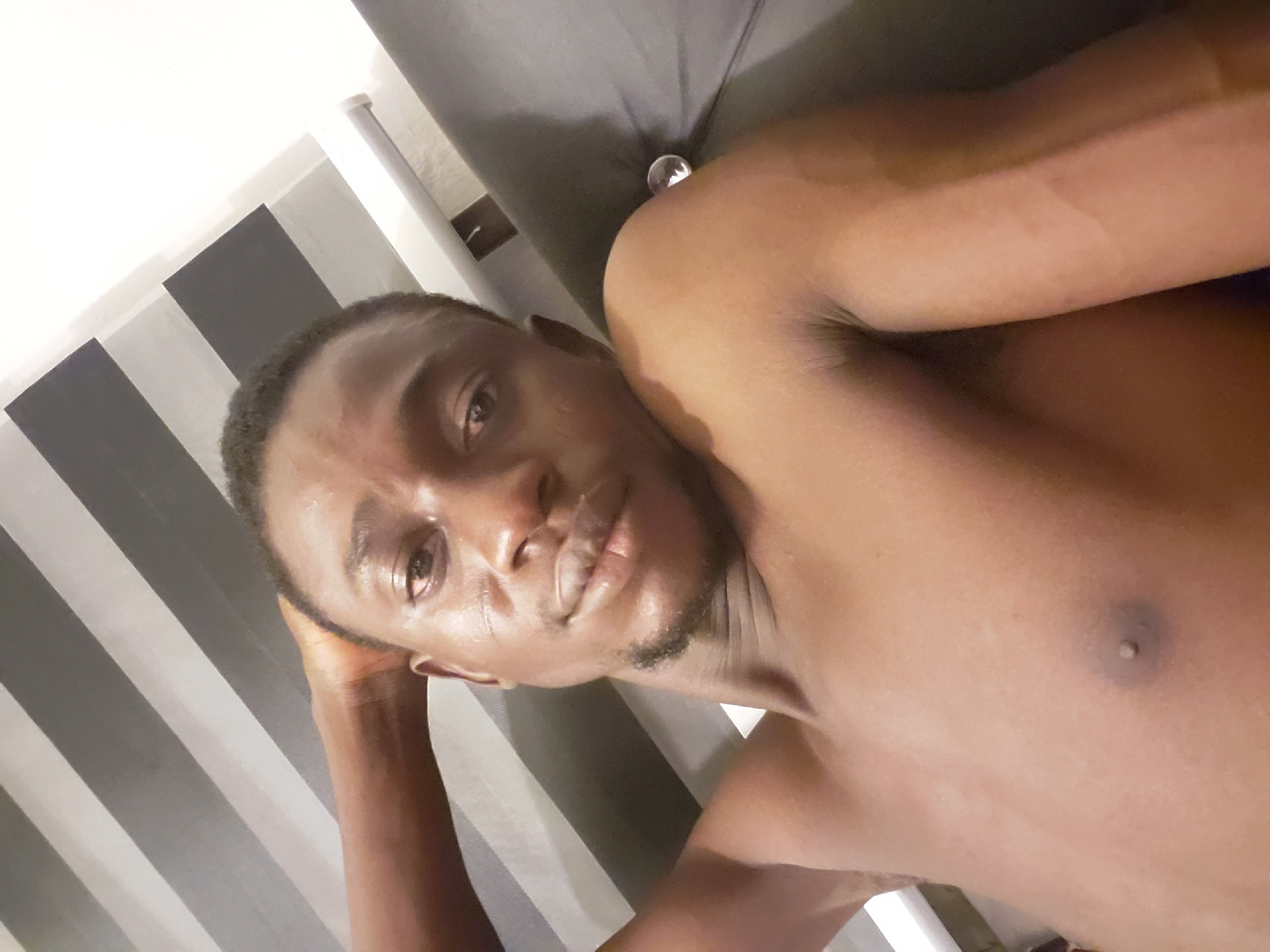 Man takes multiple selfies while resting in Adonkolo, Nigeria