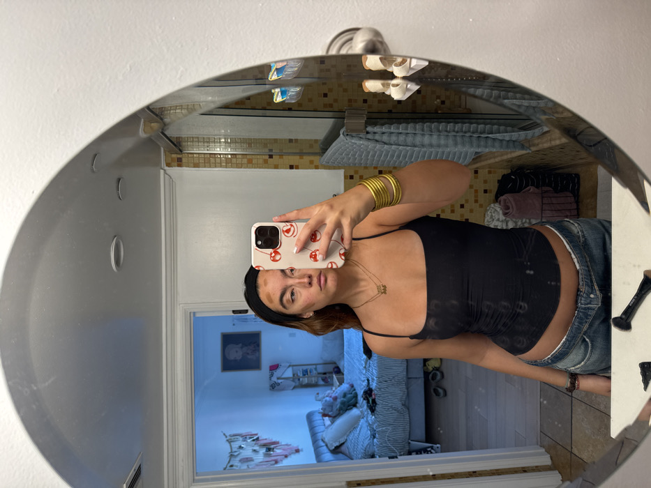 Person takes mirror selfie in Los Angeles bathroom