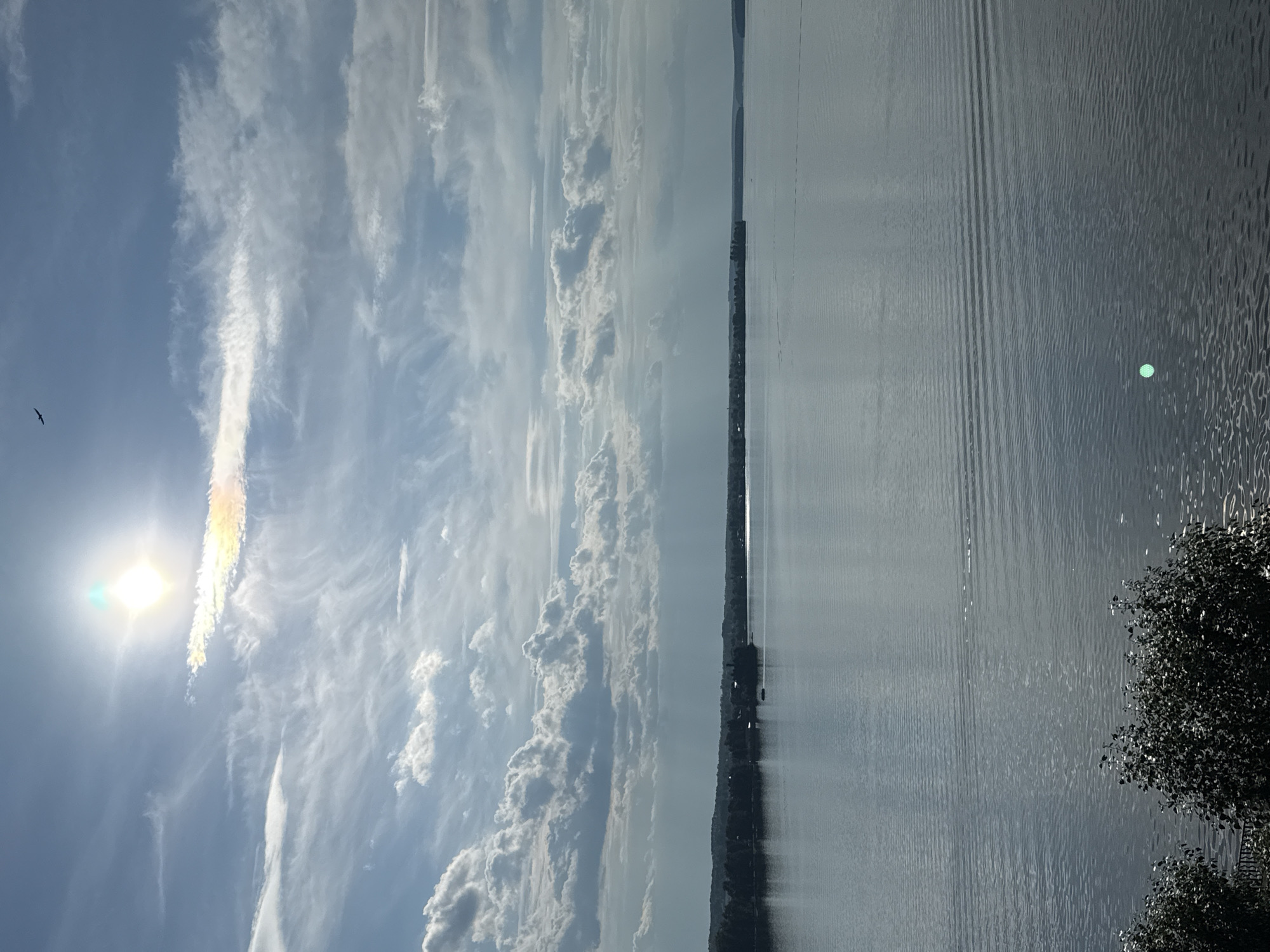 Still lake under a partly cloudy summer sky near Votkinsk