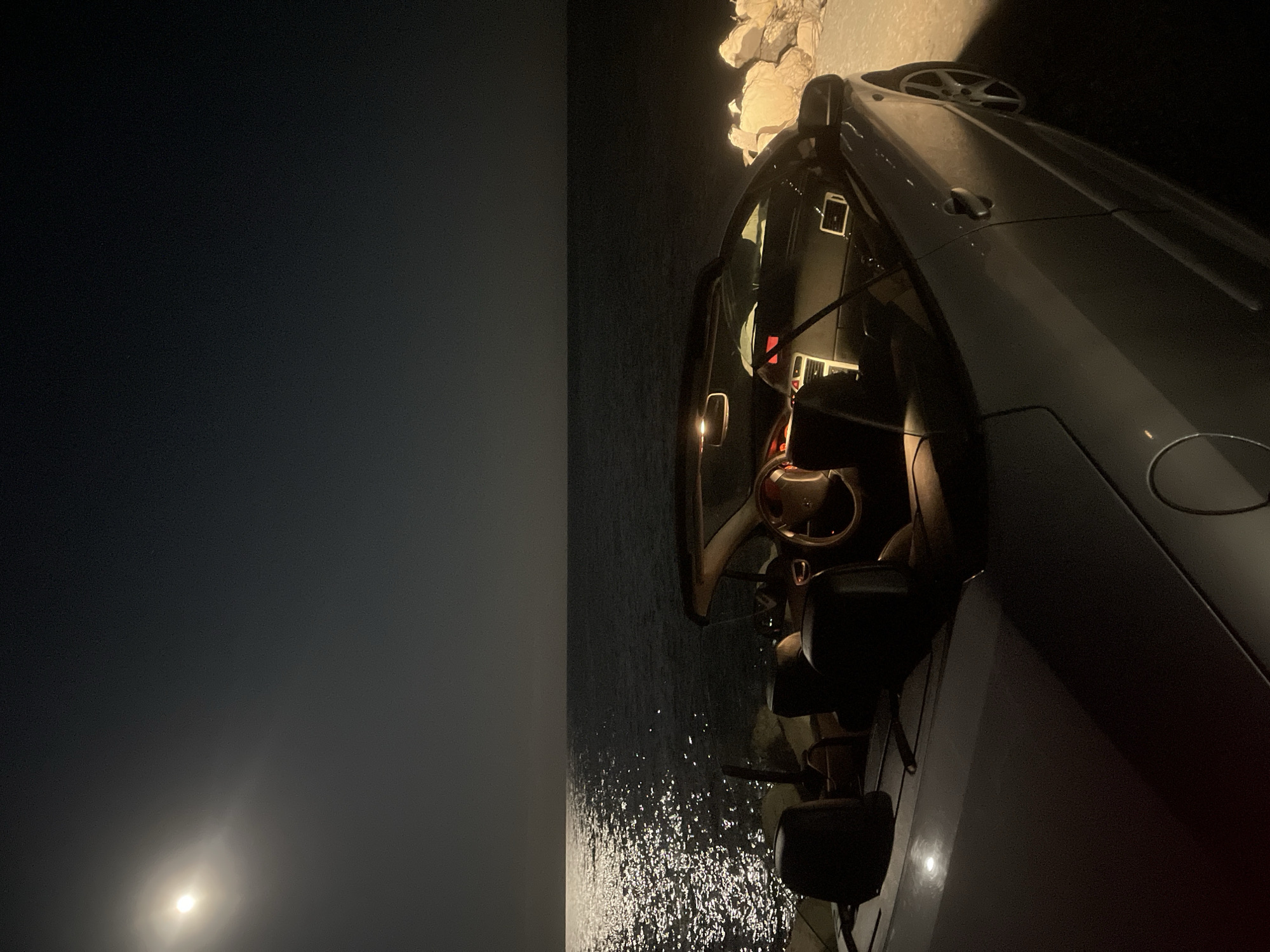 Car parked on Varna cliffs during moonlit evening