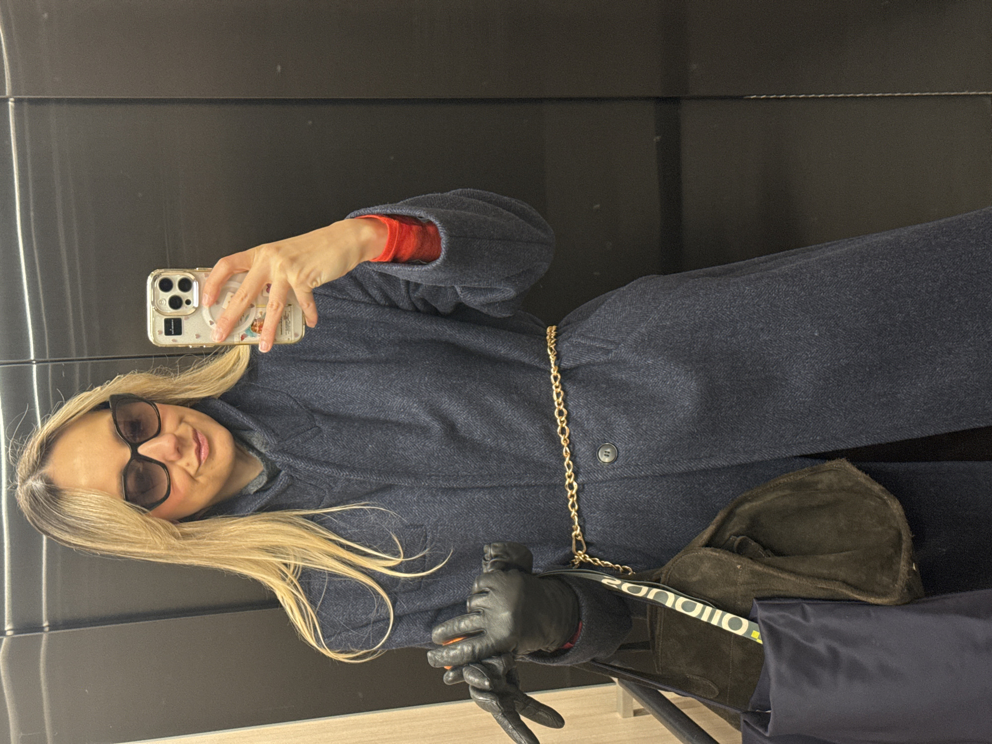 Woman takes morning selfie in reflective surface in Riga