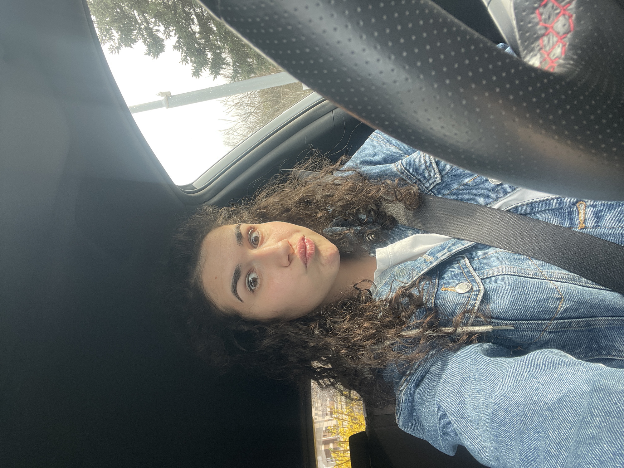 Woman takes playful car selfie in Sofia