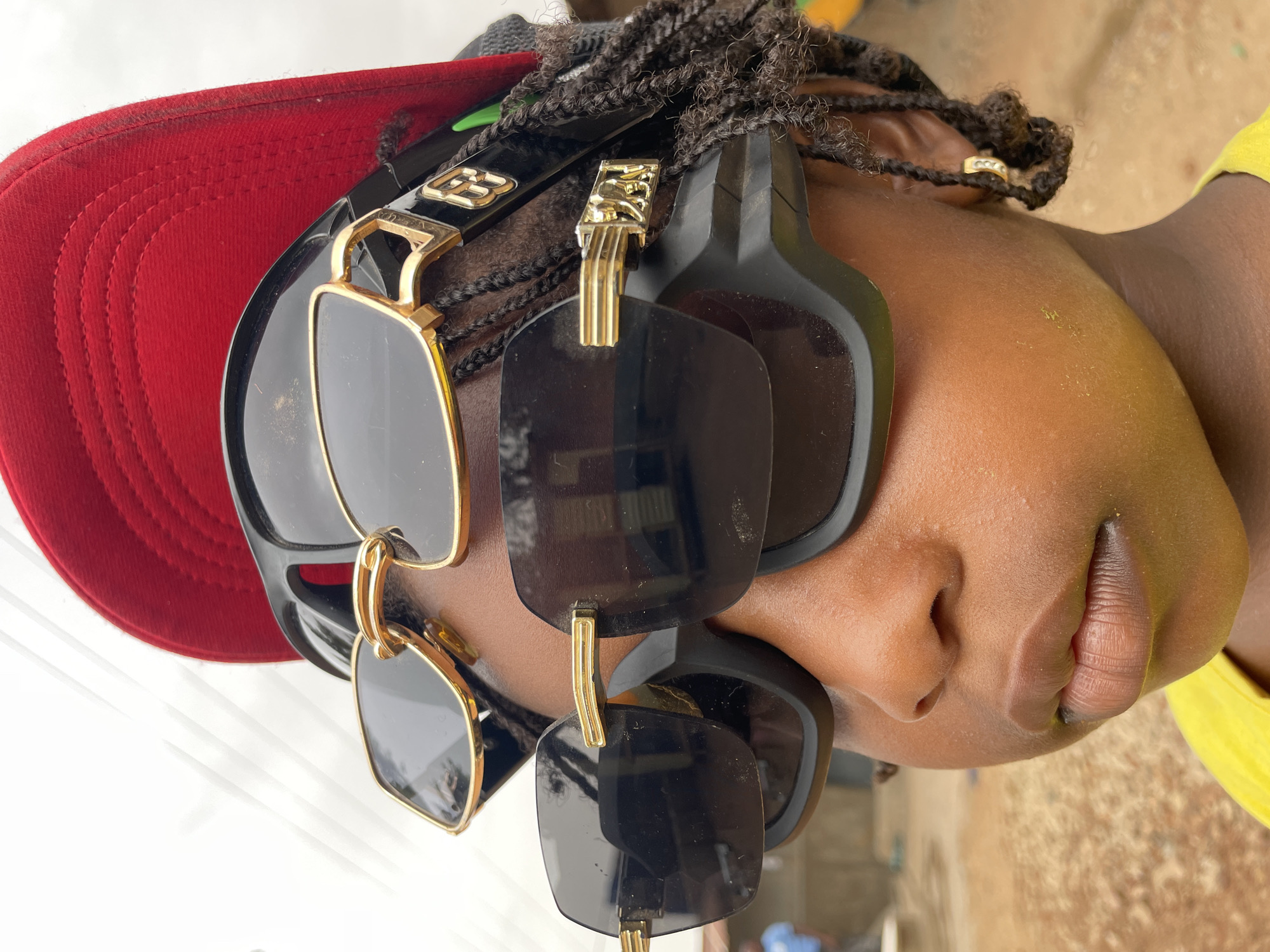 Street scenes captured in Jos show locals with phones, caps