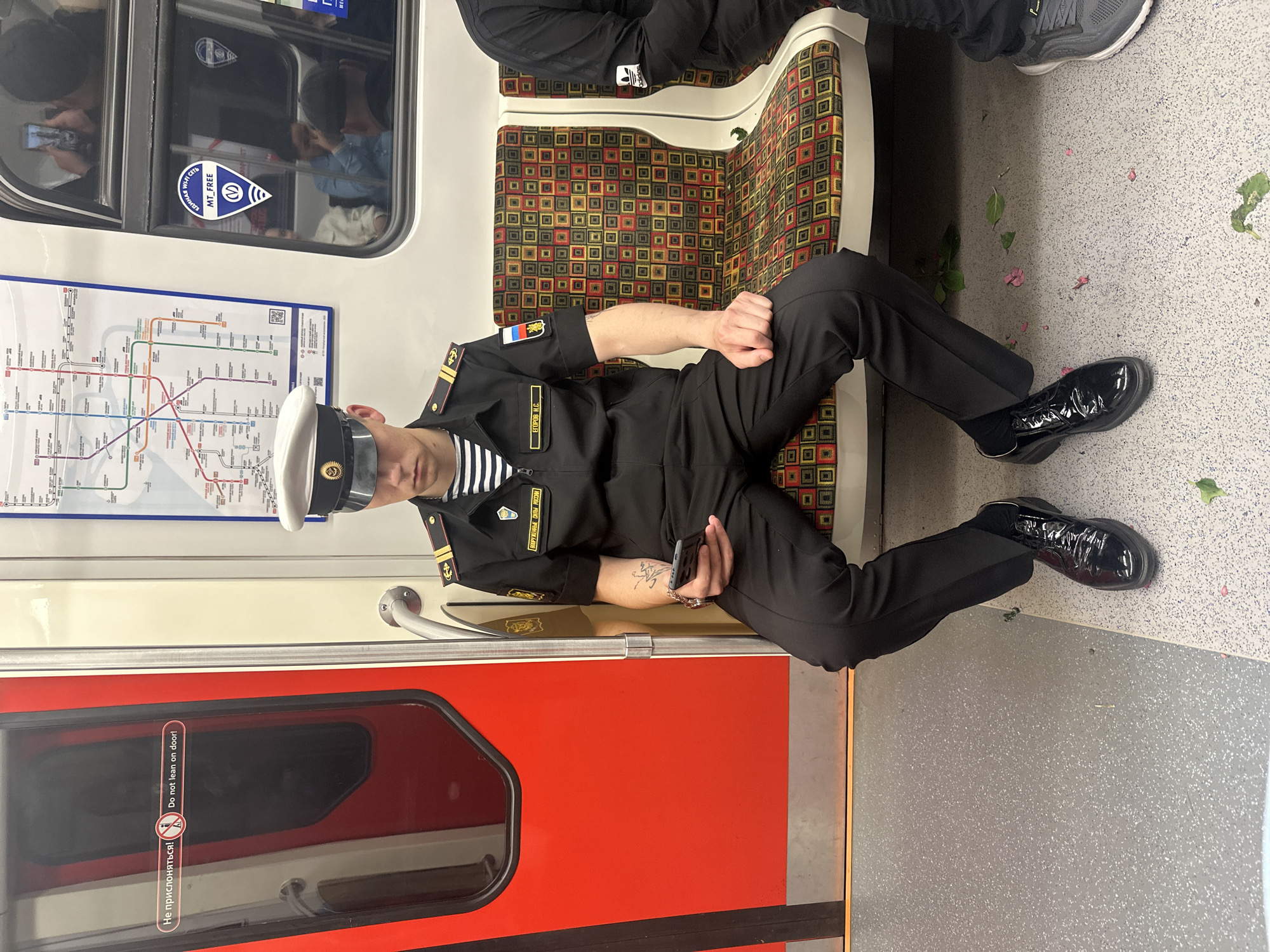 Russian naval officer rides Saint Petersburg subway with smartphone