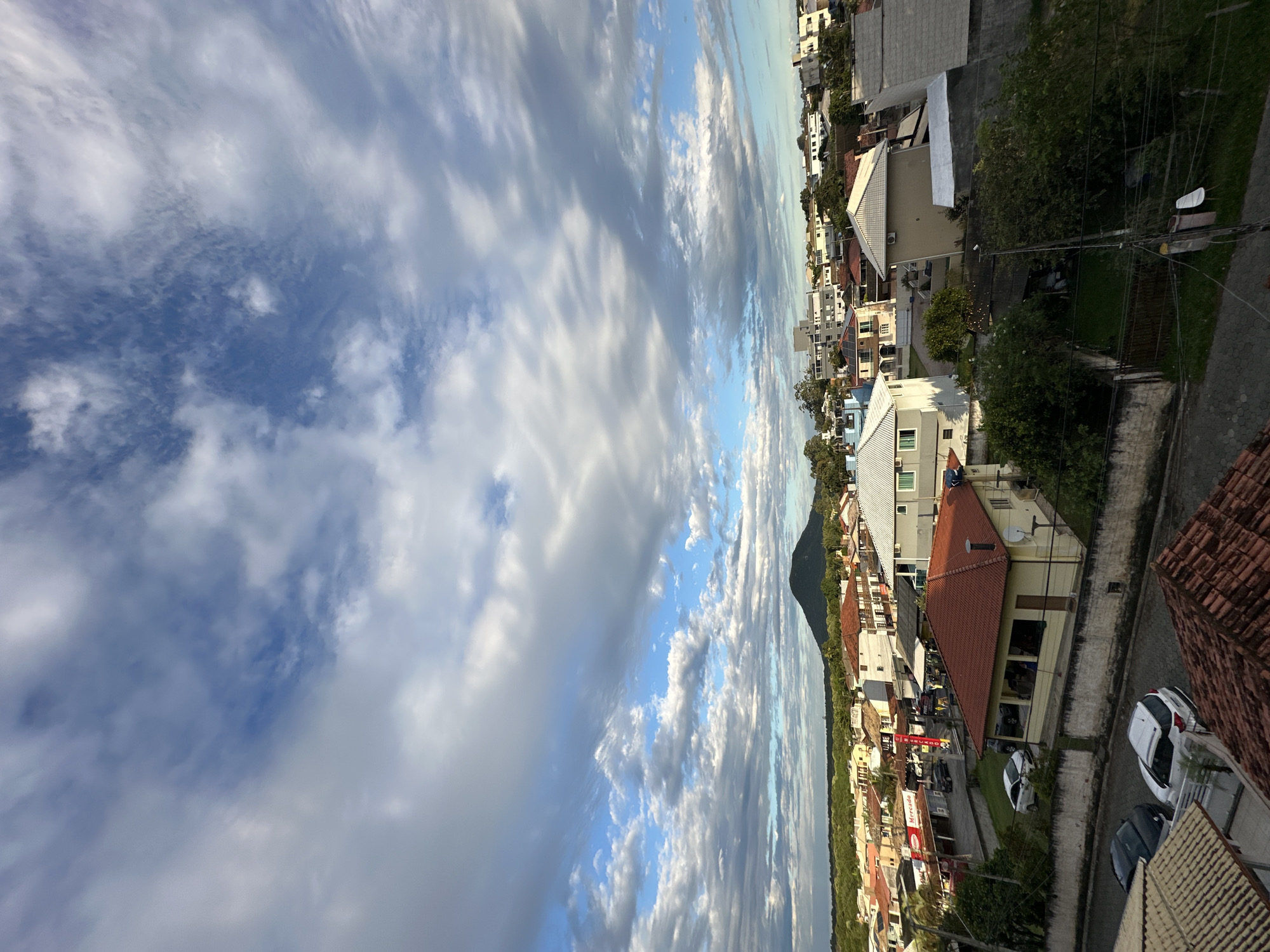 Residential Florianópolis neighborhood documented under partly cloudy evening skies