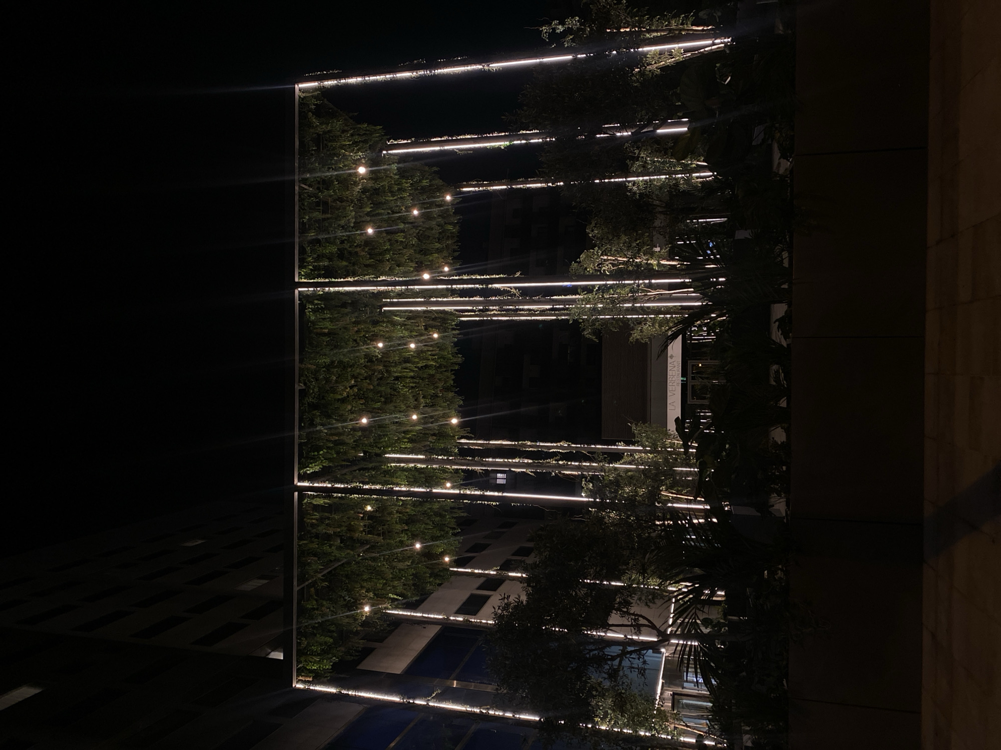 Barcelona commercial area features illuminated landscaping at night