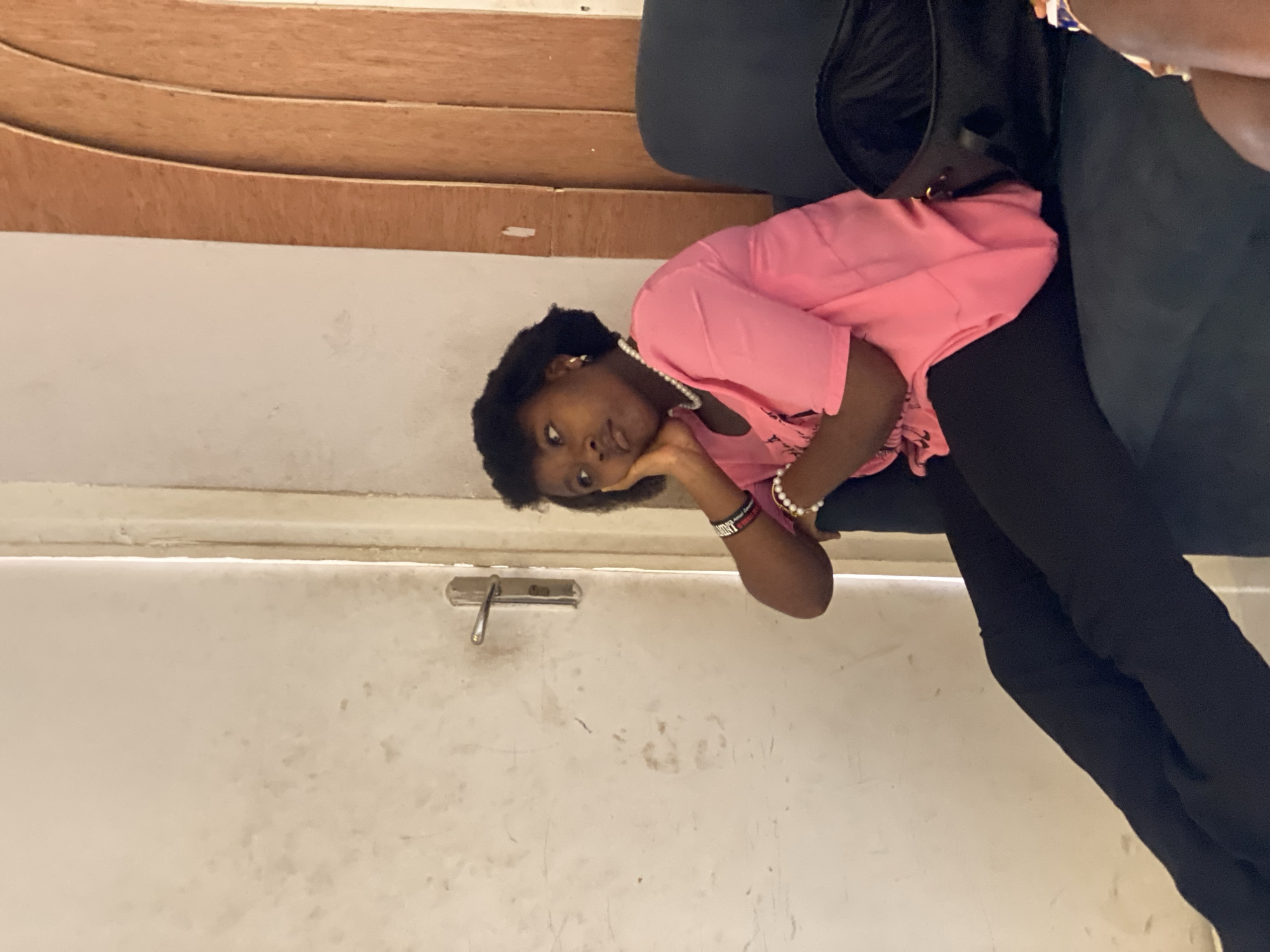Young adults gather indoors during quiet moments in Badagry