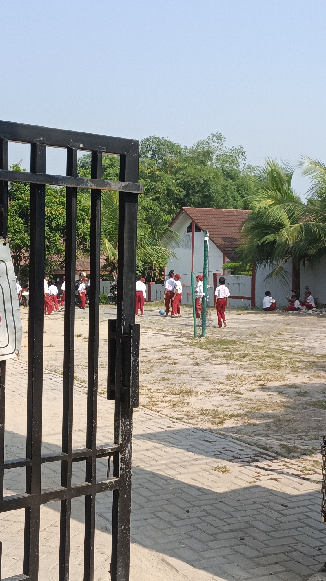 Indonesian schoolchildren play volleyball during early morning recess
