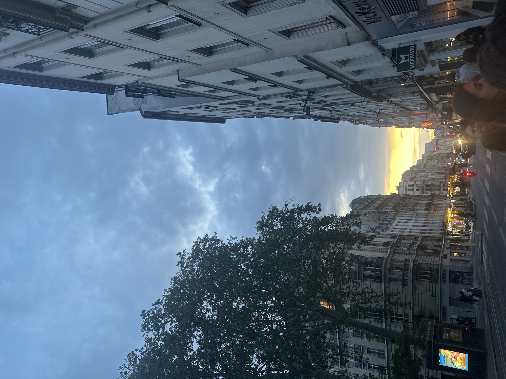 Paris street scene captured at dusk with varied architecture