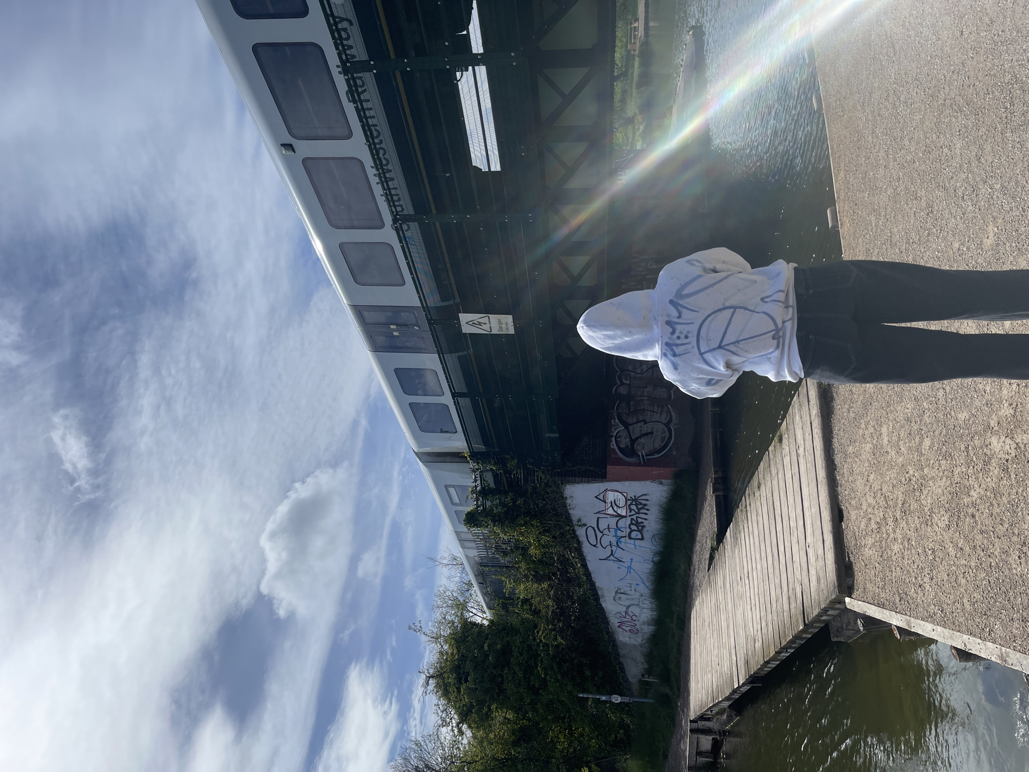 Afternoon stroll captured along Portsmouth waterway with passing train