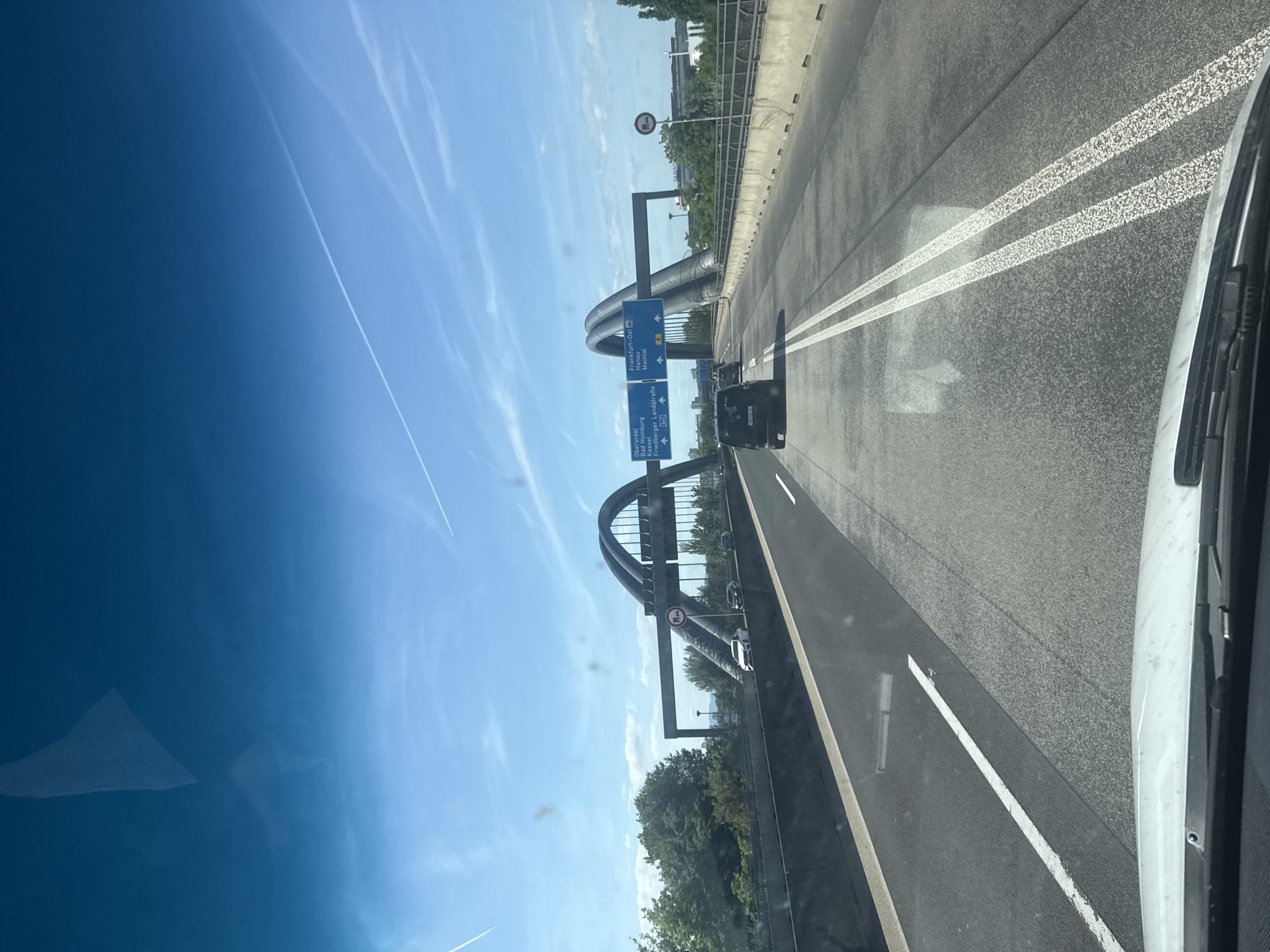 Vehicle crosses Nidda Bridge on Frankfurt autobahn during afternoon drive
