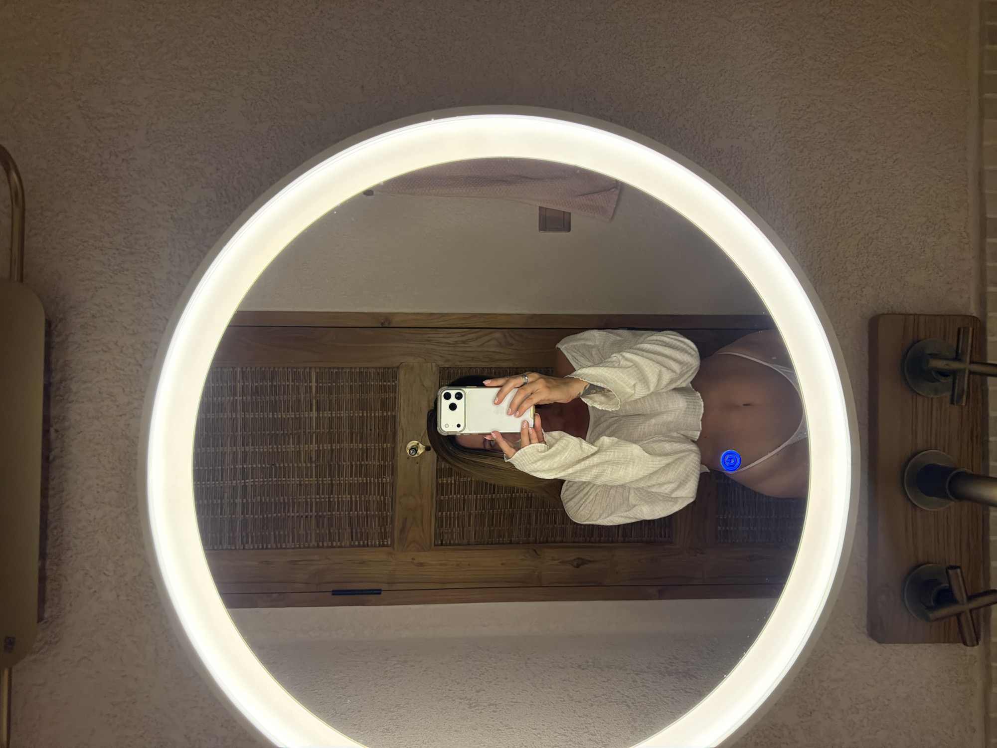 Woman takes bathroom mirror selfies in Mengwi, Indonesia