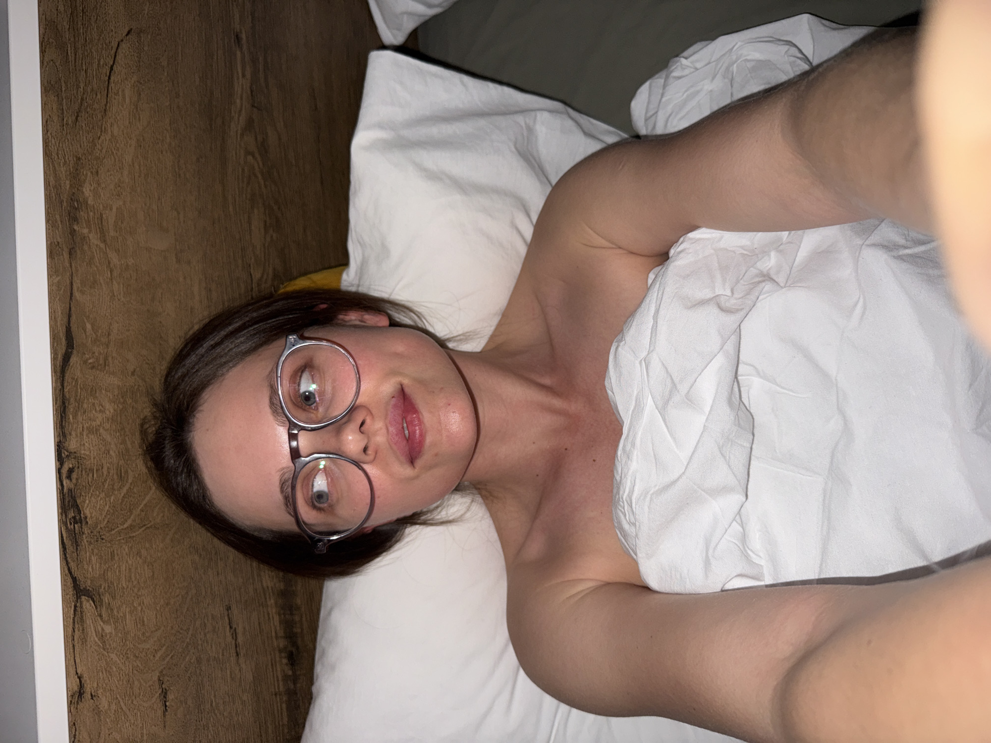 Woman photographed in bed in Budapest apartment