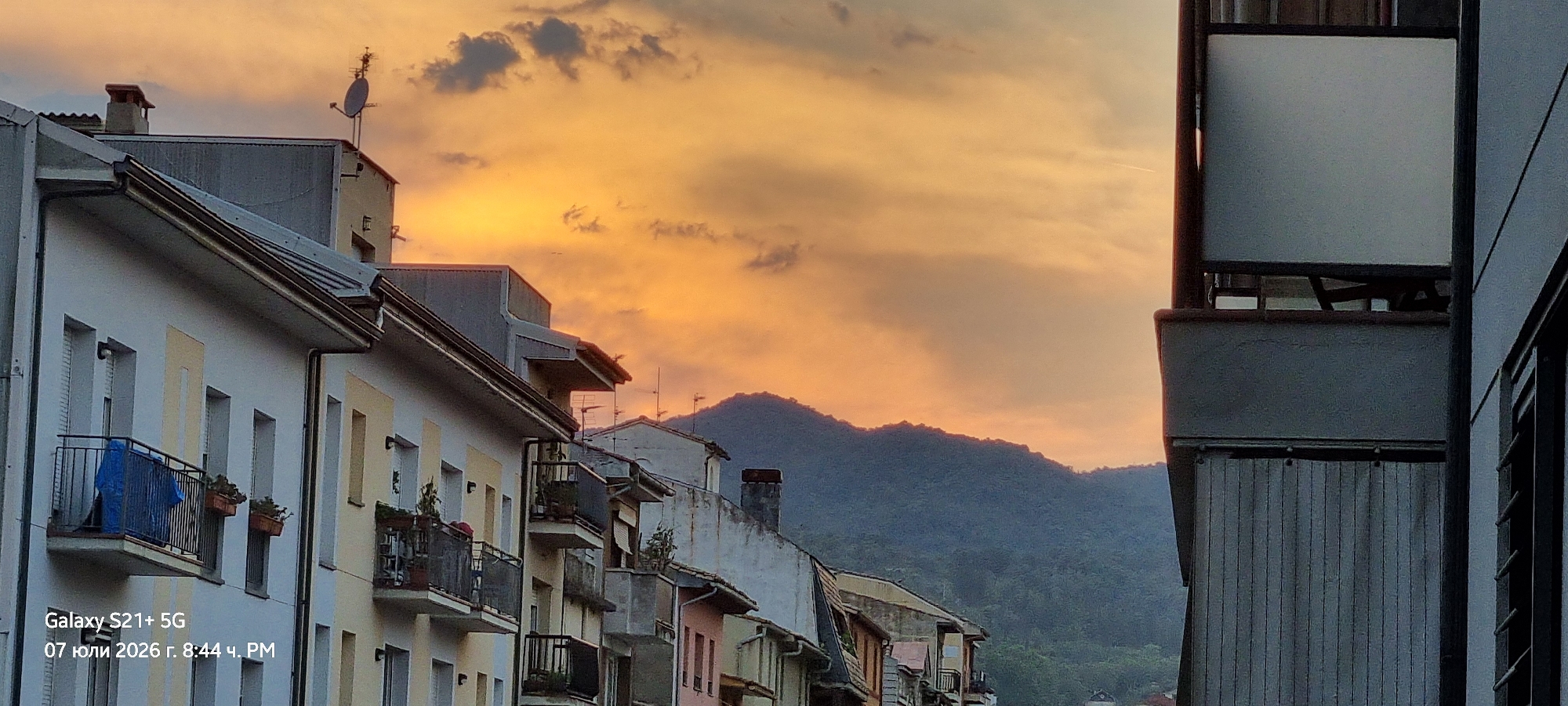 Sunset drinks on a terrace overlooking a mountain town